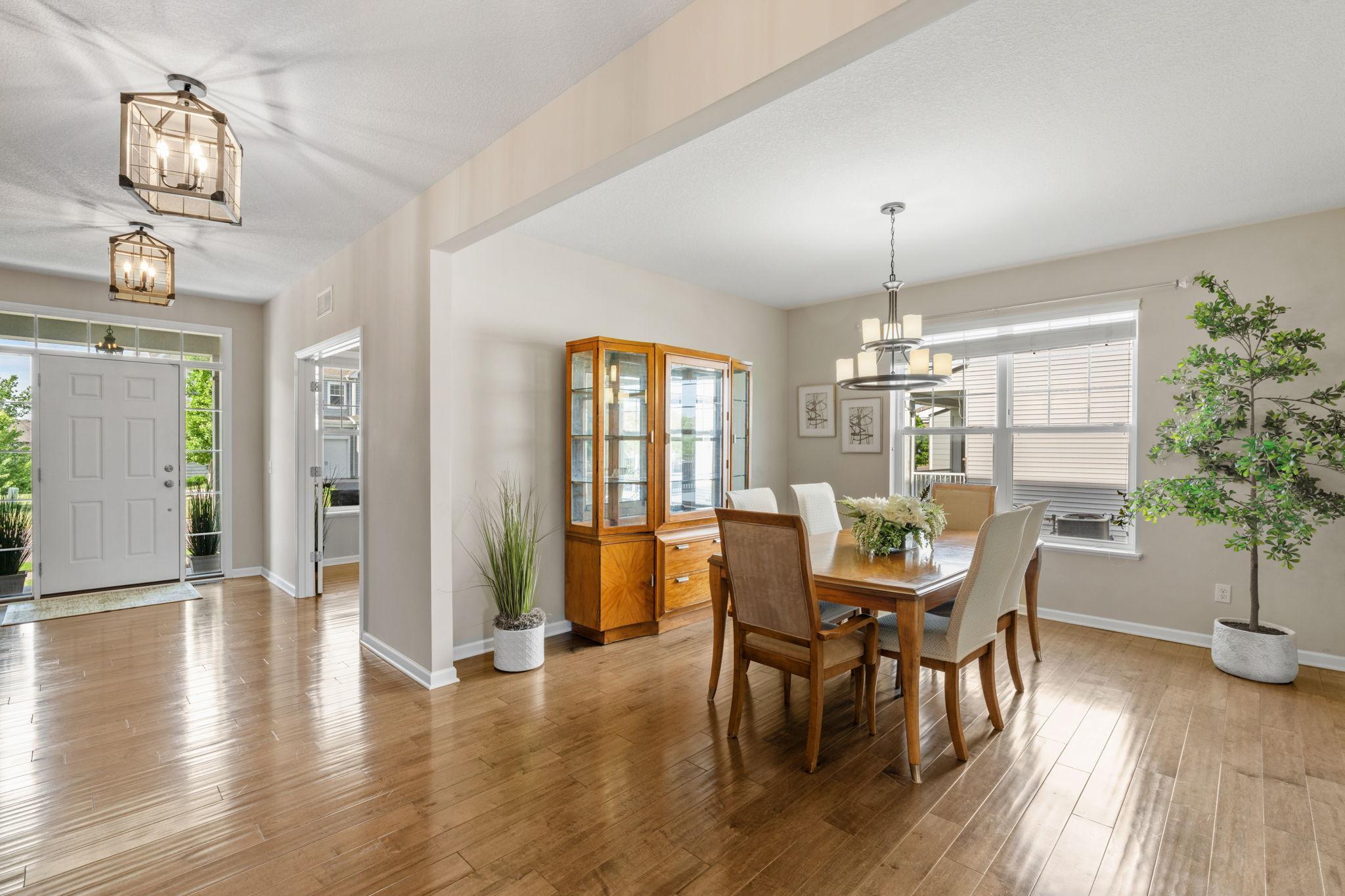 Transition effortlessly from the foyer into a spacious, sunlit formal dining space complete with an elegant chandelier and plenty of room for a hutch.