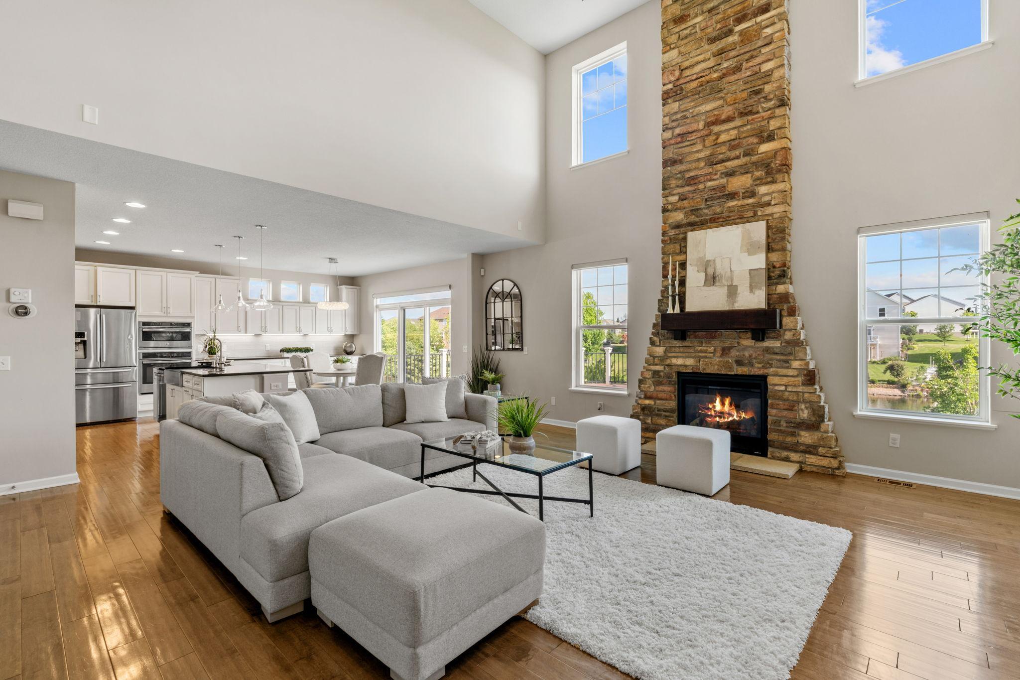 Multiple oversized windows frame scenic pond views and flood the spectacular two-story great room with glorious afternoon light.