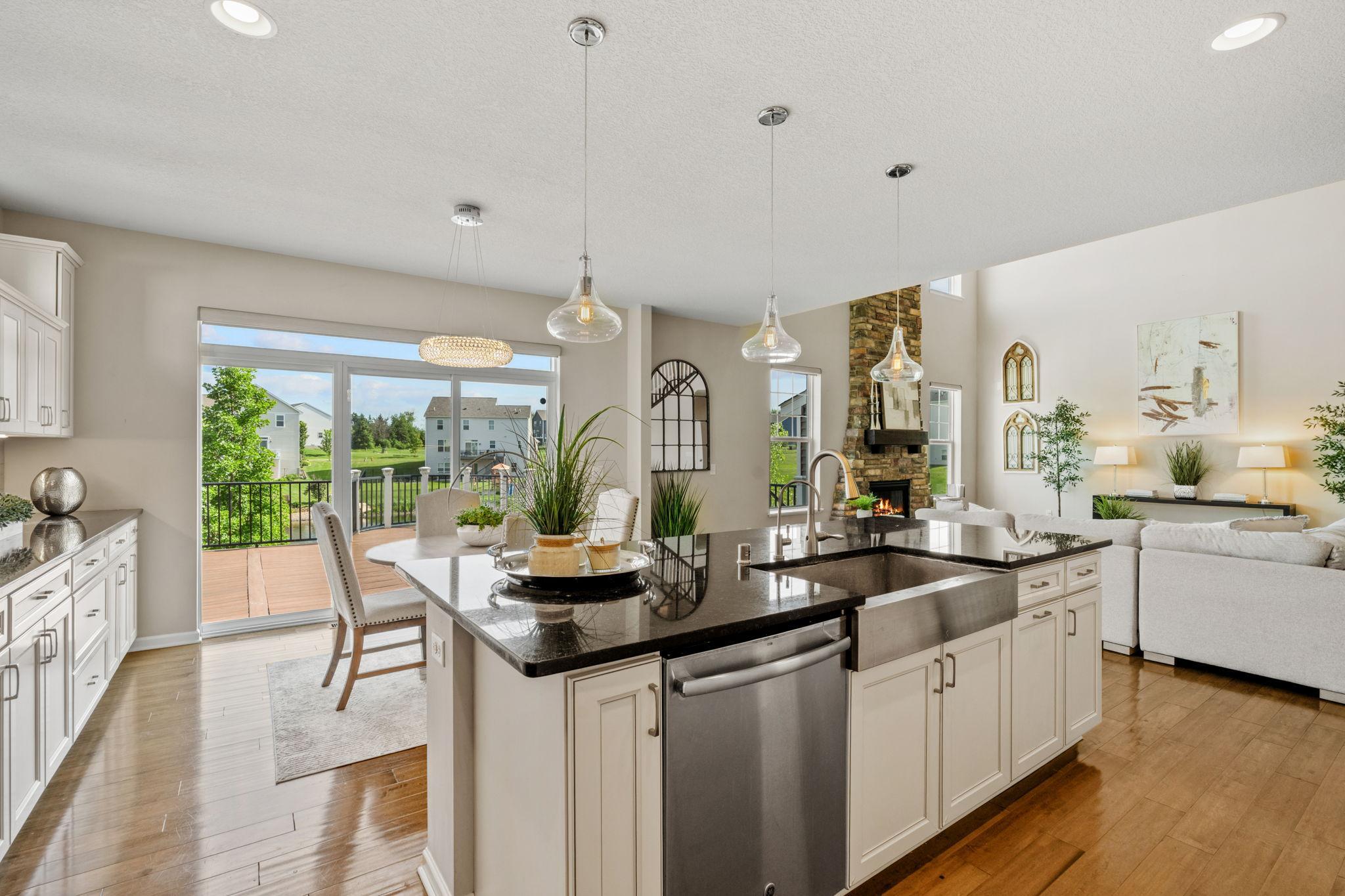 View from the kitchen island shows how seamlessly the space transitions into both the dining nook and the stunning living areas.