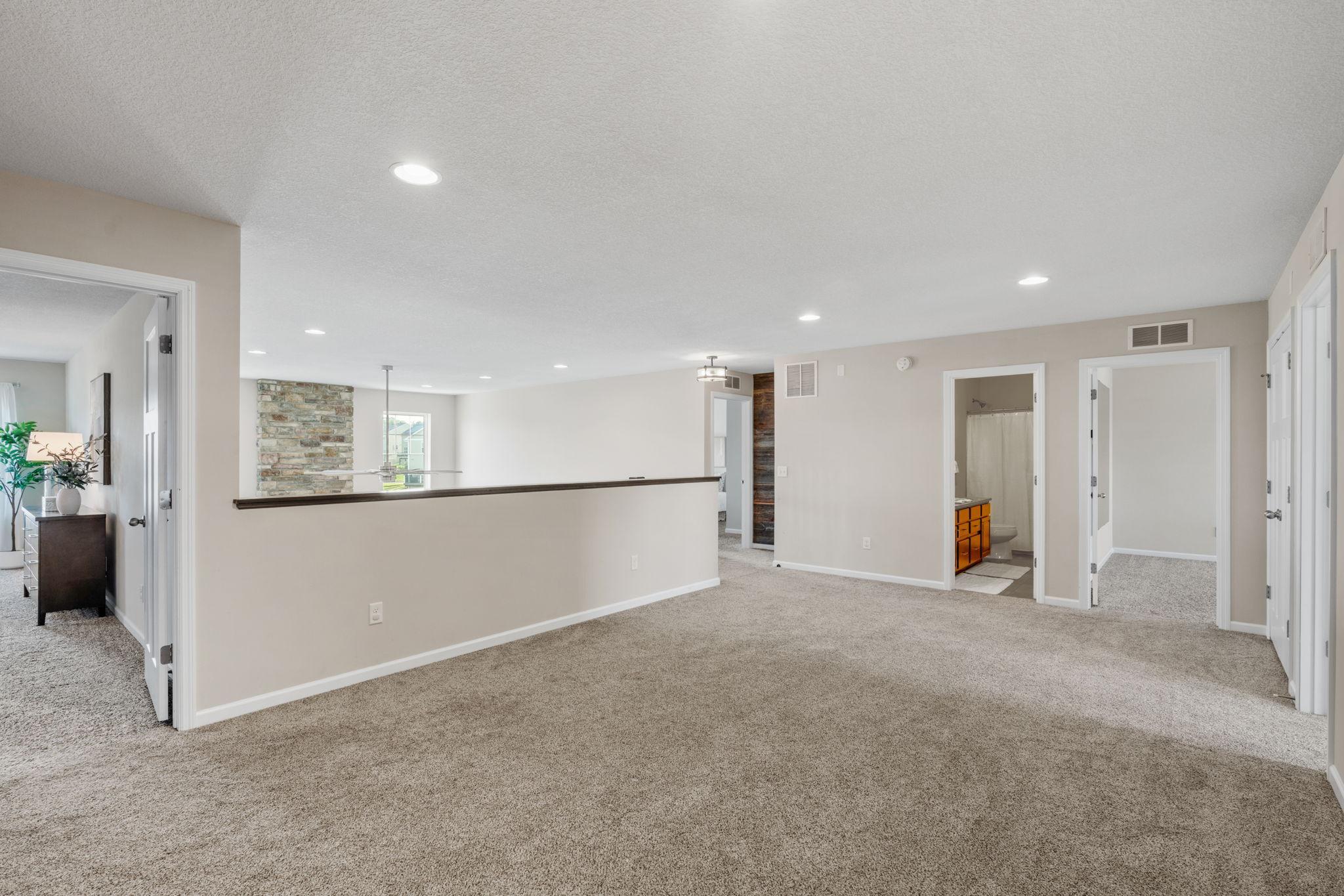 An oversized, open loft area welcomes you to the upper floor, offering a vast second living zone or a media retreat.