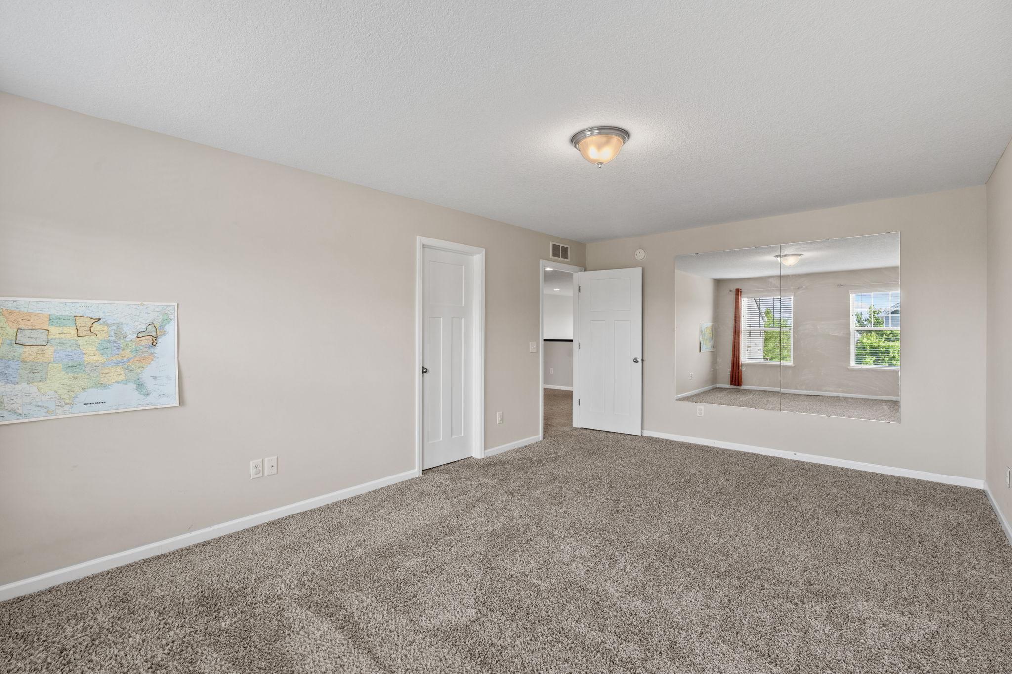 Perfectly sized for a bedroom, playroom, or exercise space, featuring a massive wall-mounted mirror and large Walkin closet.