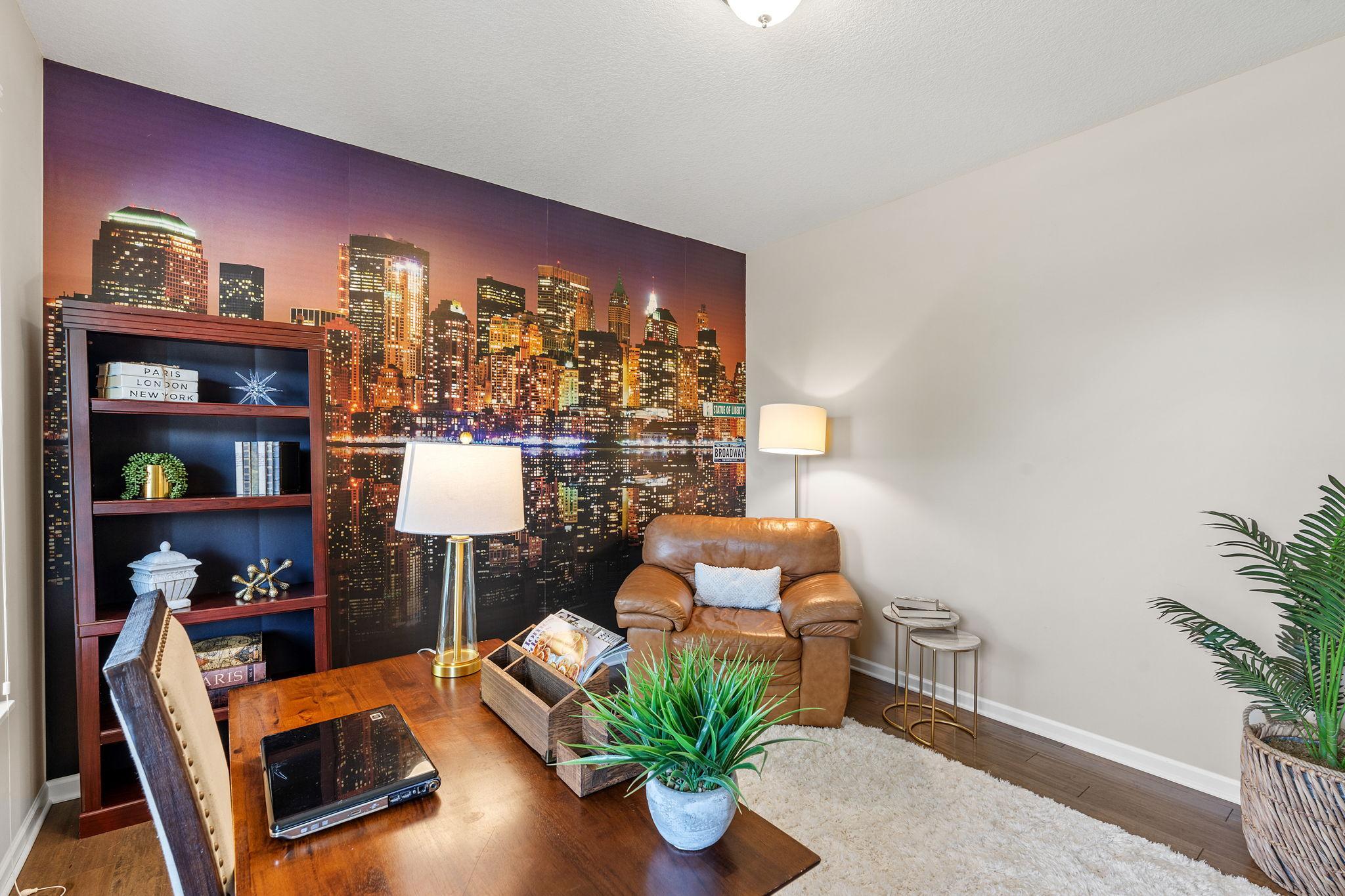 Generous room proportions easily accommodate a full-size desk, shelving units, and comfortable additional seating.