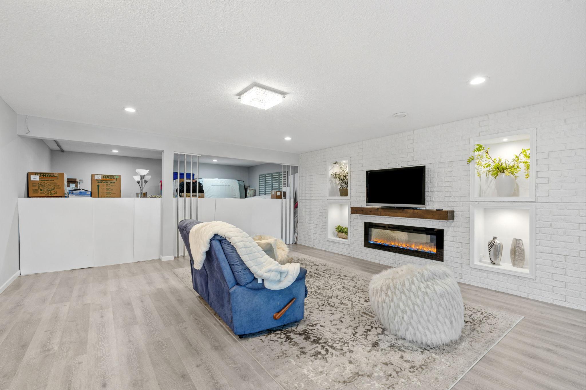 Escape to the spectacular finished basement, featuring modern wide-plank flooring, inset storage alcoves, and a separate unfinished storage area.