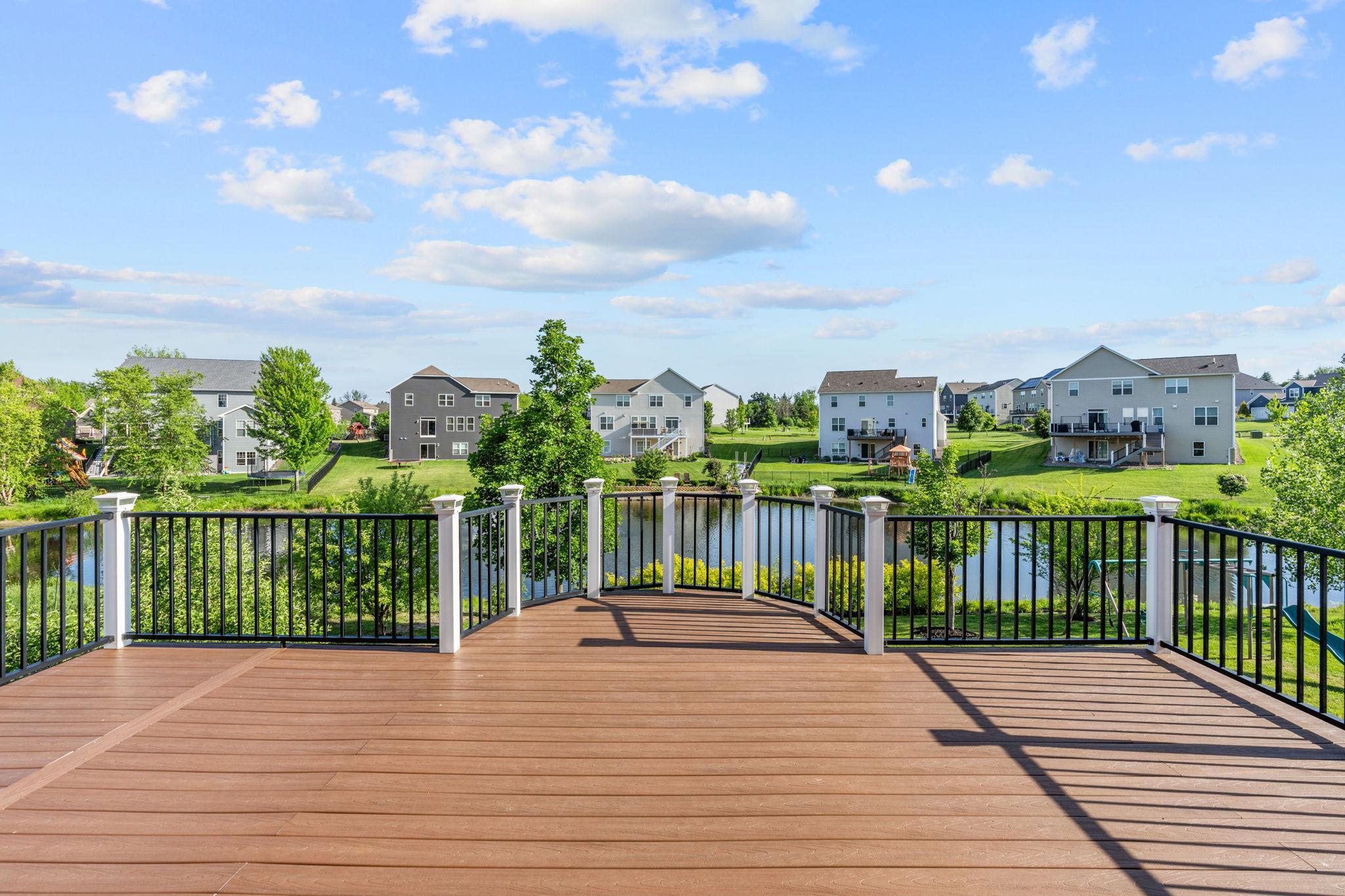Take in stunning, elevated vistas of the community pond and fountain straight from your private composite deck.