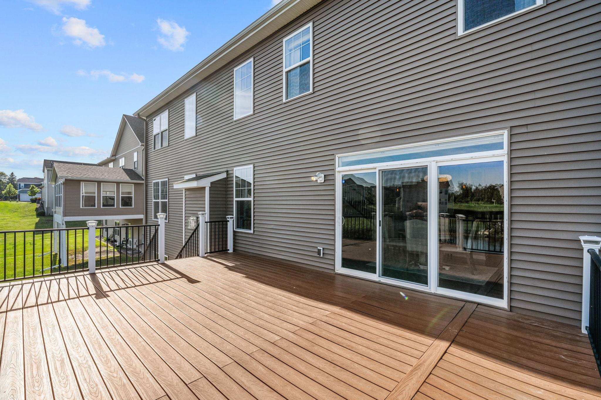 Sliding glass doors lead directly from the main living areas onto the deck, making it perfect for summer grilling and outdoor dining.