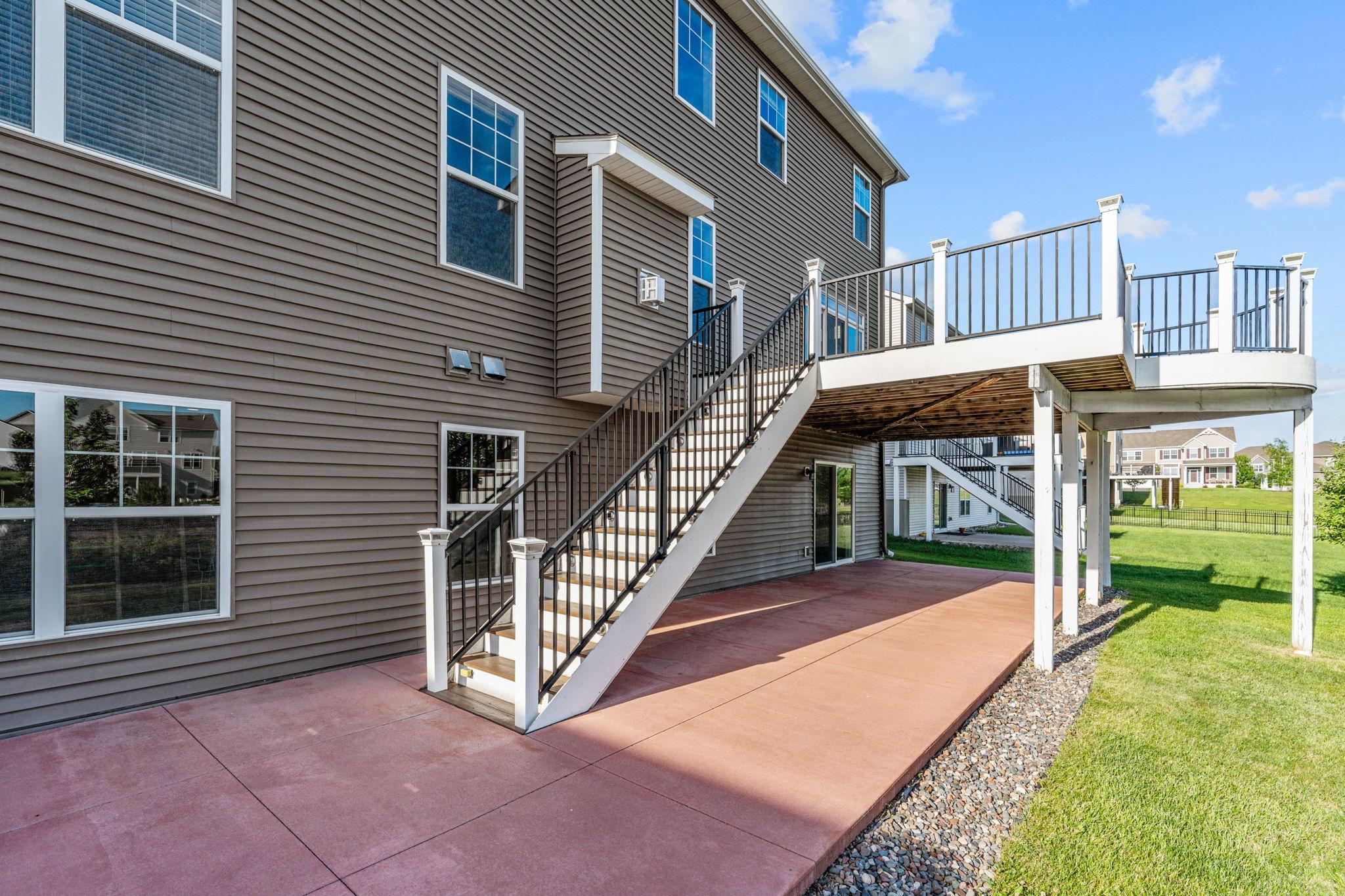 Sturdy, well-maintained stairs connect the upper entertaining deck to the lower patio, making indoor-outdoor transitions a breeze.