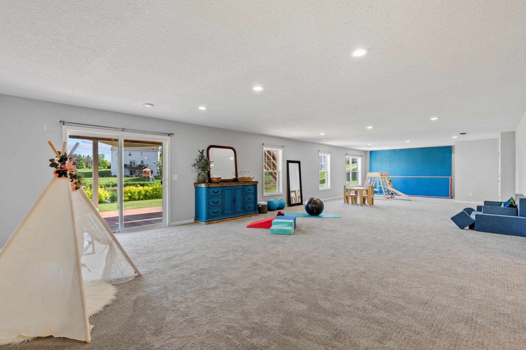 Showcasing the true, incredible scale of this walk-out basement—perfectly configured for a massive children's playroom, home gym, or billiard space.