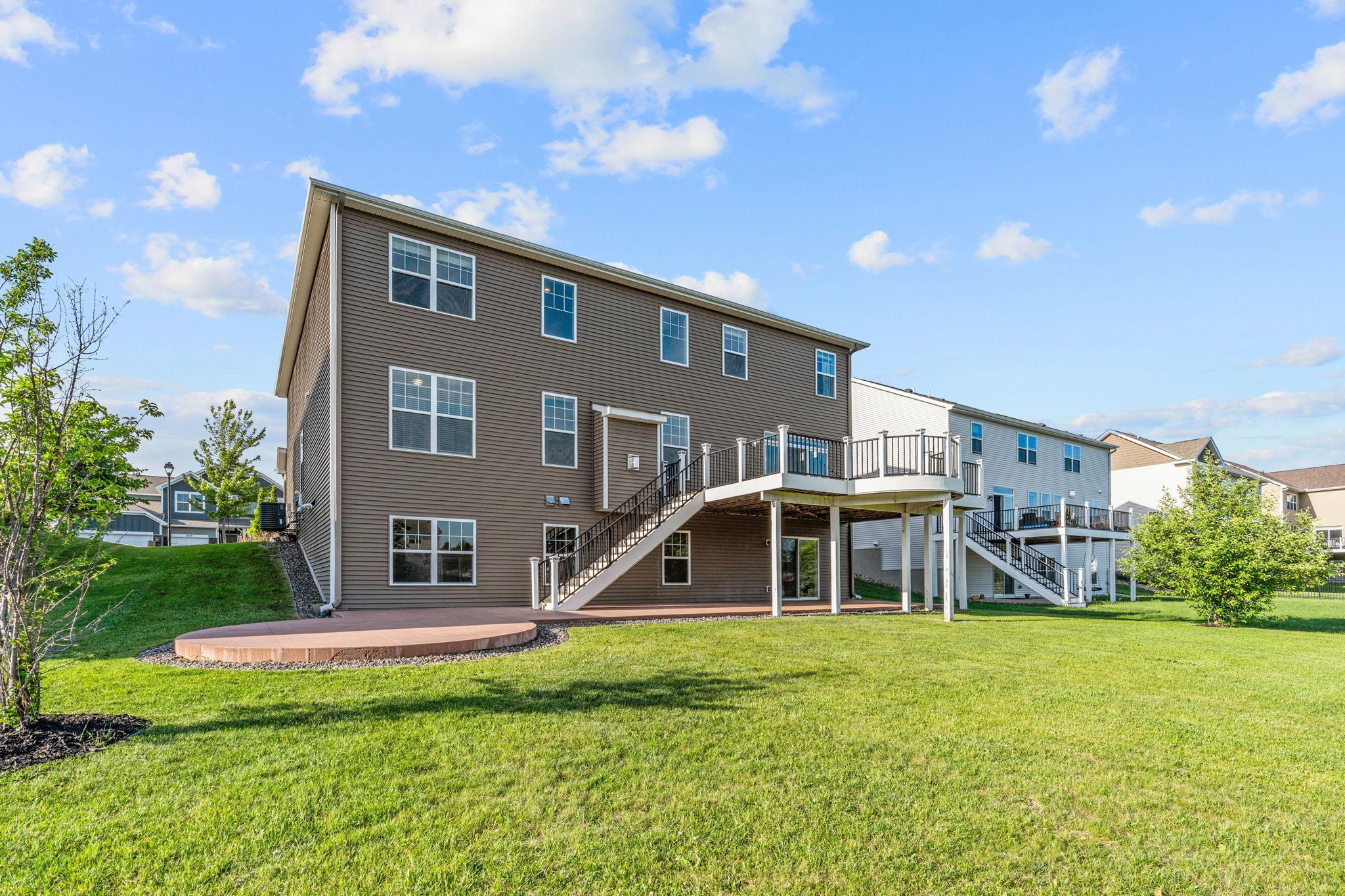 An angled look at the massive, flat backyard offering plenty of open green space for recreation, gardening, or future customized outdoor additions.