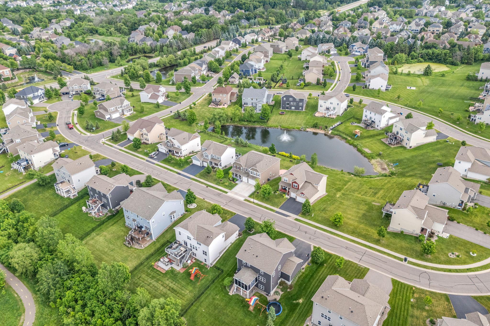 High-altitude aerial view showcasing the home’s exceptional placement within a clean, modern, and highly sought-after community.