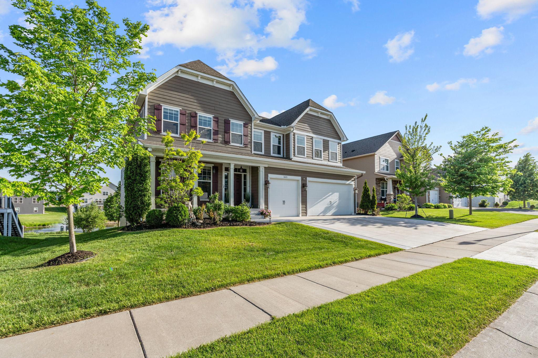 Enjoy the lush, vibrant green lawn and professional landscaping that frames the property perfectly, accentuating the expansive corner-to-corner lot size.