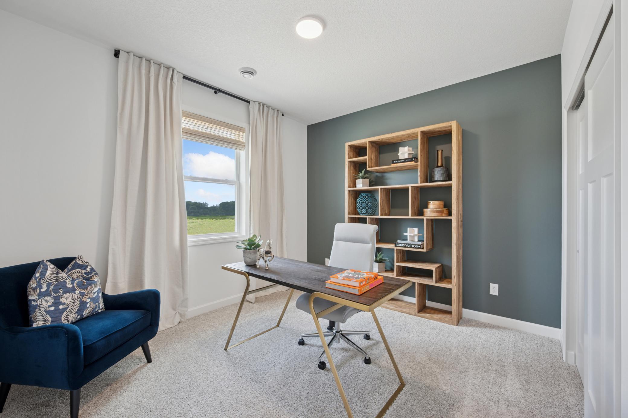 (Photo of a decorated model, actual homes finishes will vary) One of the secondary bedrooms can be used as an office as shown here!