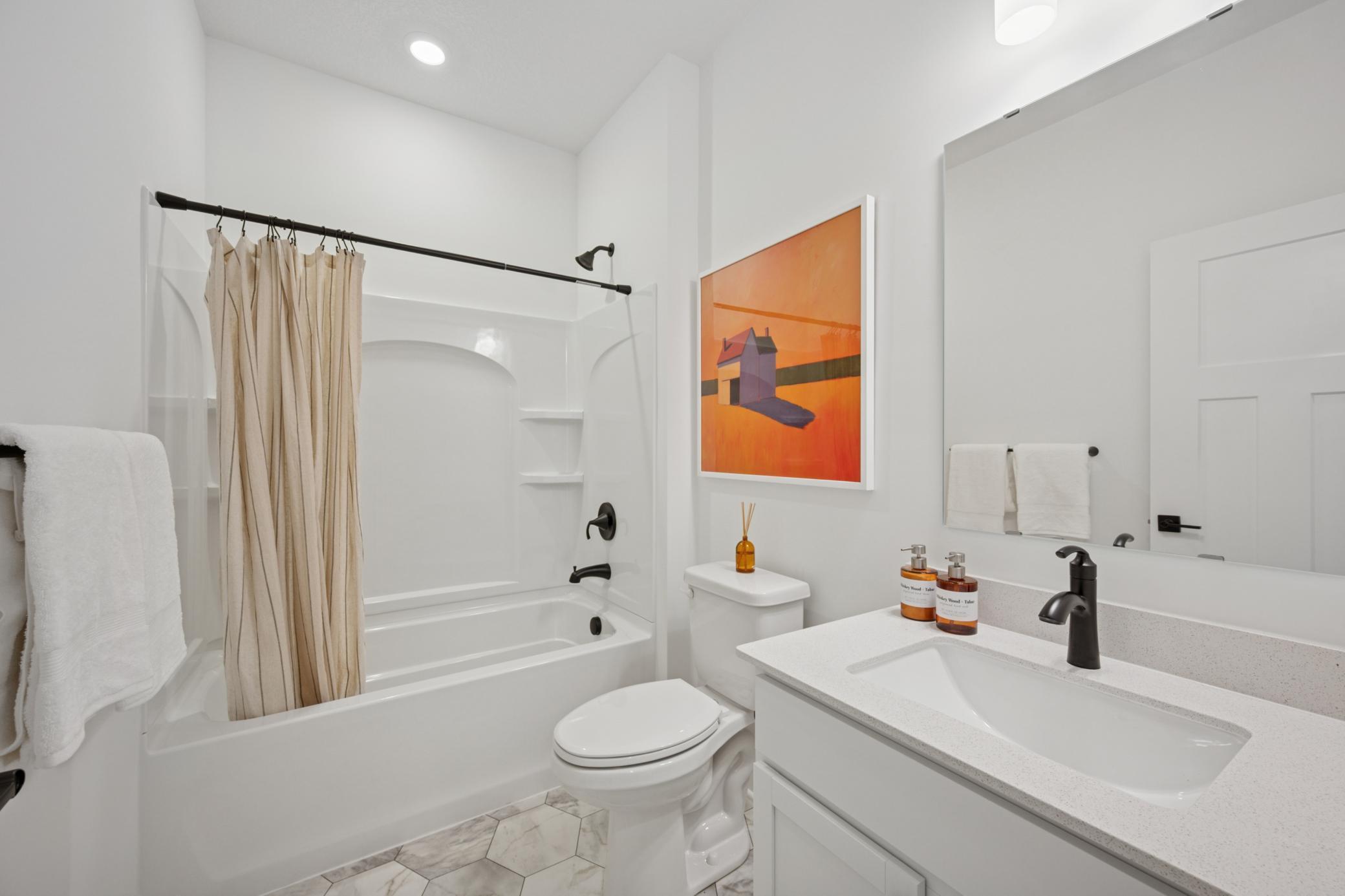 (Photo of a decorated model, actual homes finishes will vary) The secondary bath!