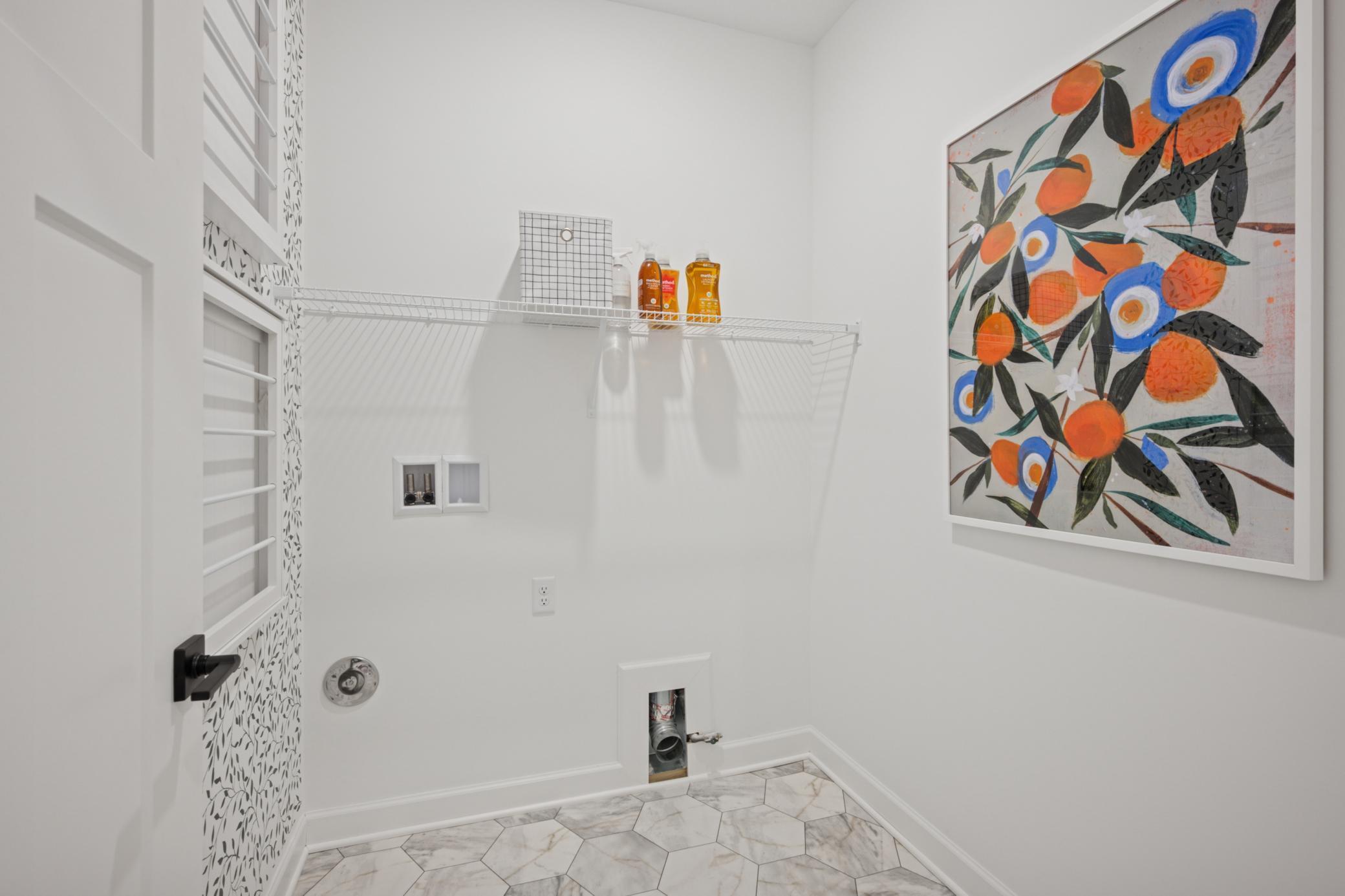 (Photo of a decorated model, actual homes finishes will vary) Conveniently located laundry.