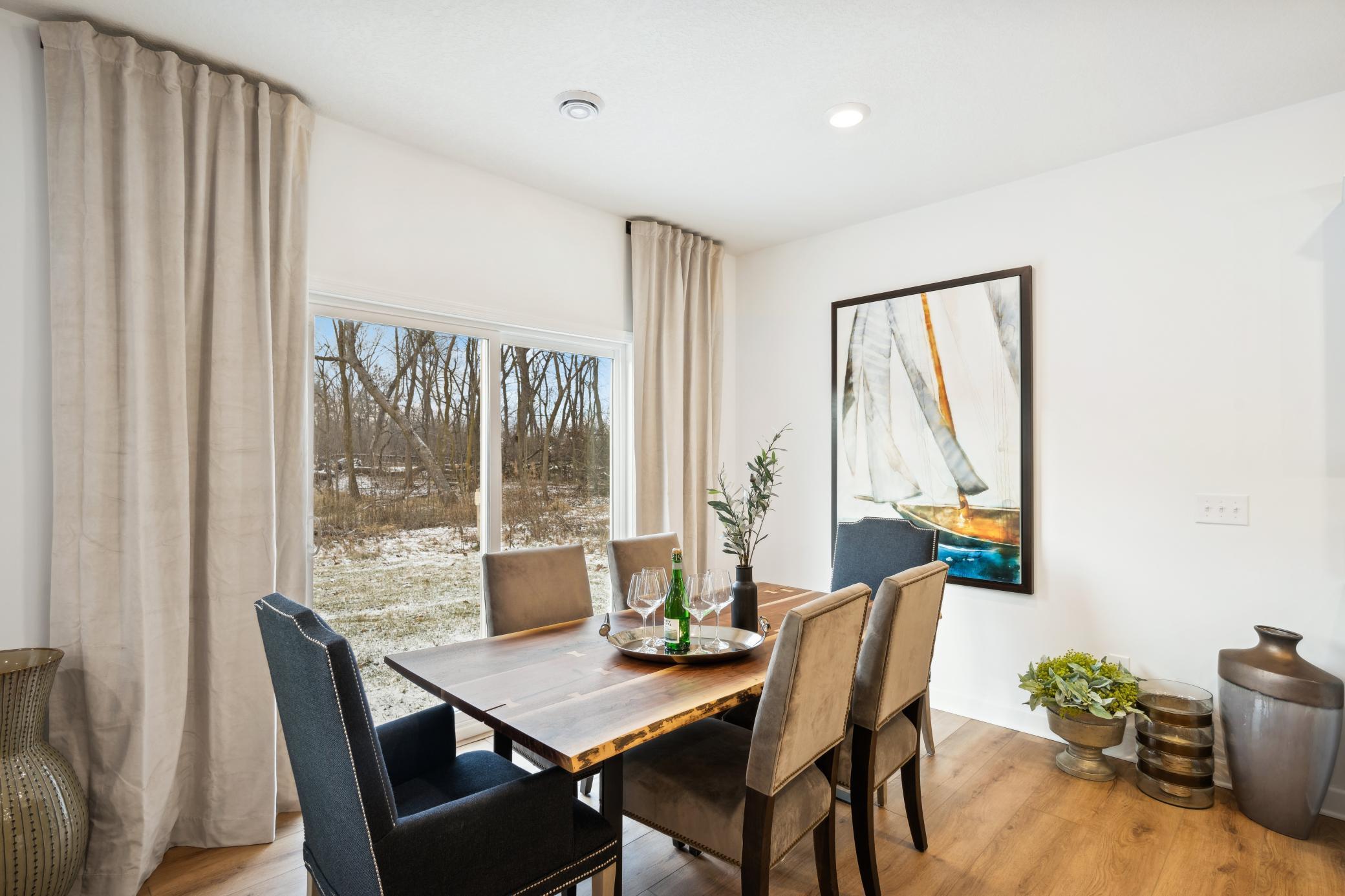 (Photo of a decorated model, actual homes finishes will vary) Soaked in natural sunlight, the home's eat-in dining room has ample space for a dining table located in the heart of the home.
