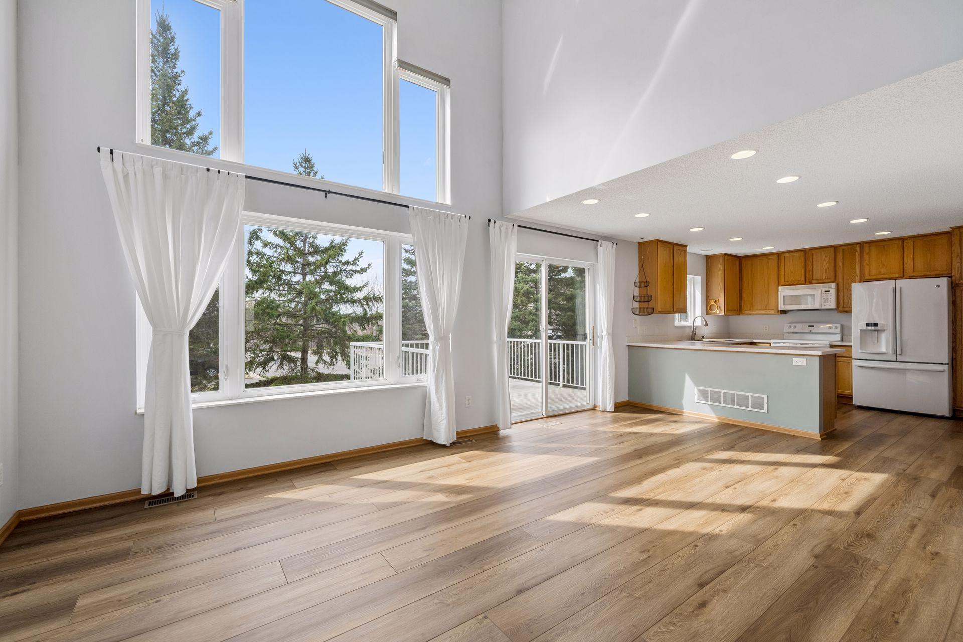 Sundrenched two-story family room is warm and inviting.