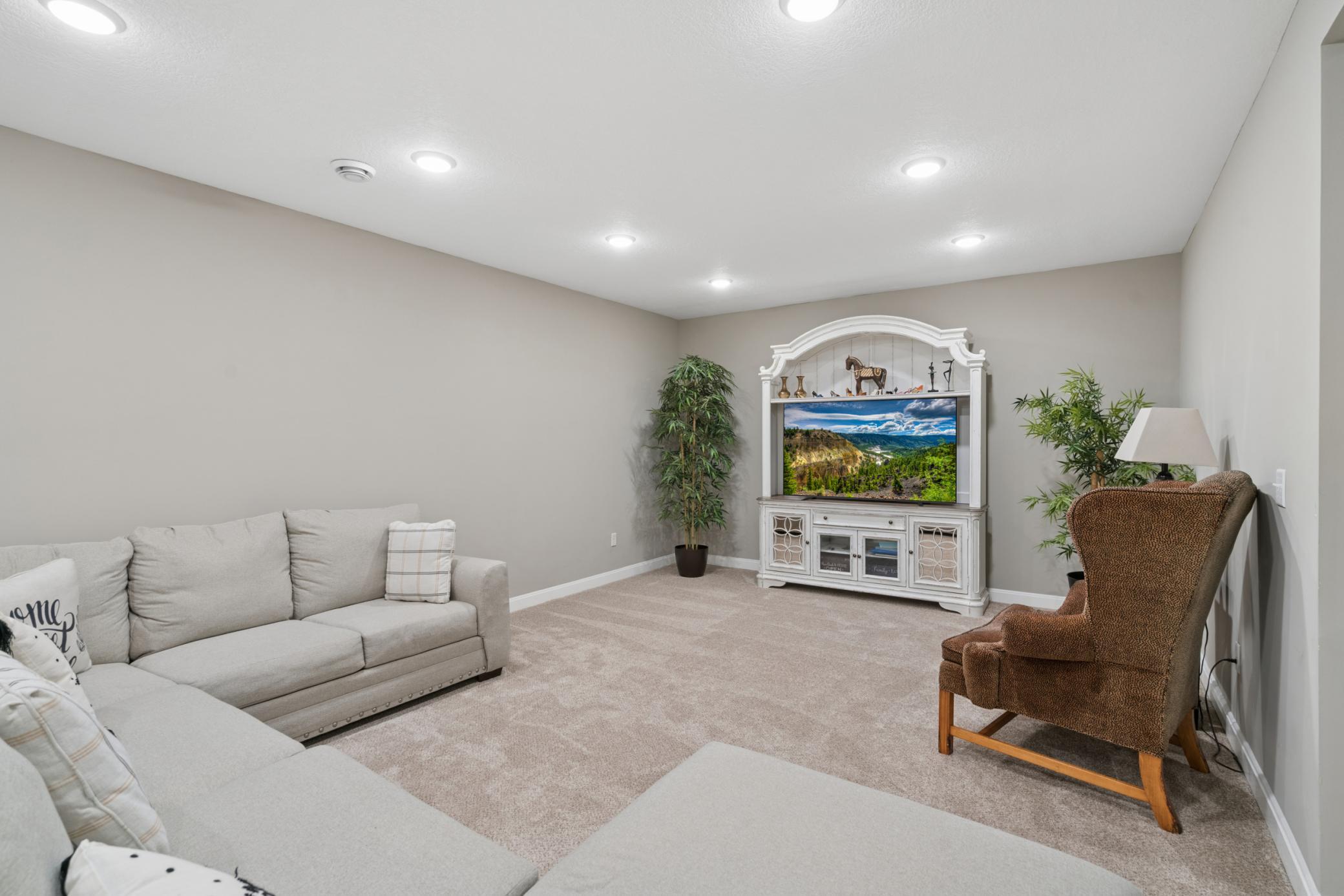 Expansive Basement Recreation Area Open-concept layout with plush carpeting