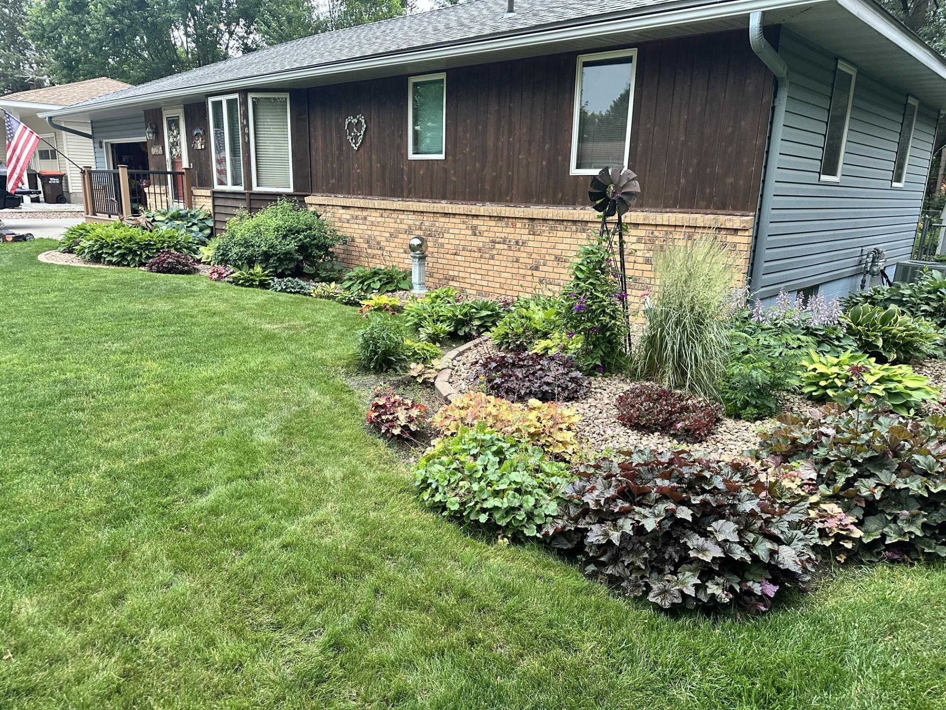 The house with the flower beds in full bloom