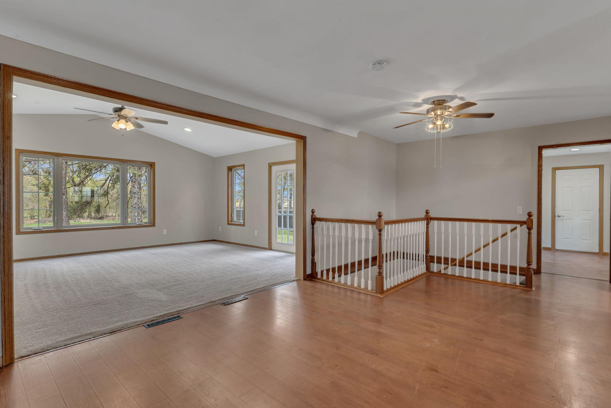 The open staircase in the dining area leads to the basement.