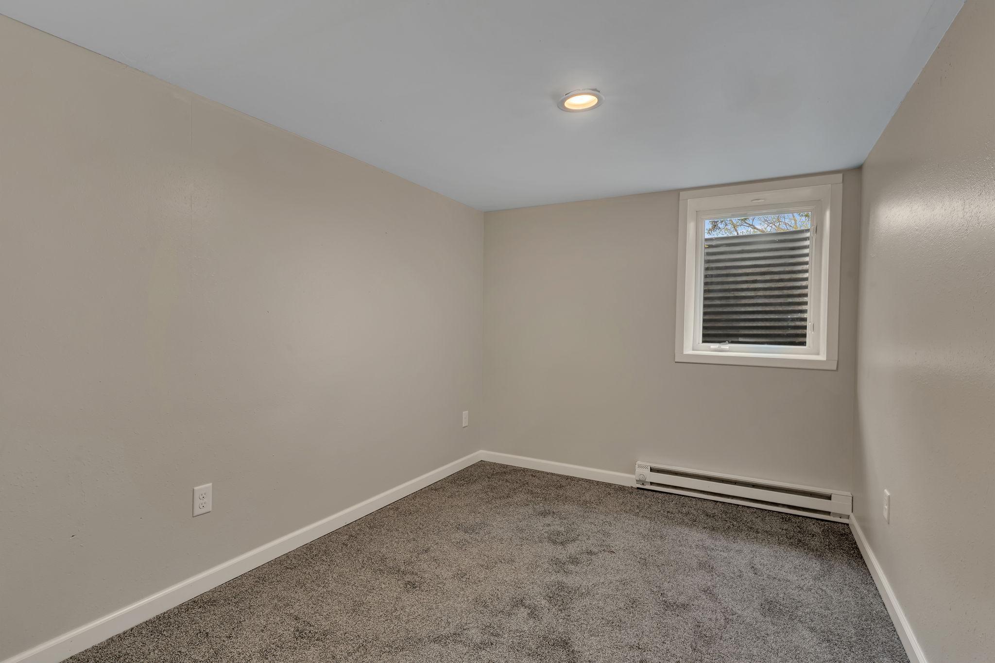 Egress window in the 4th of 4 bedrooms - electric baseboard heater is backup.