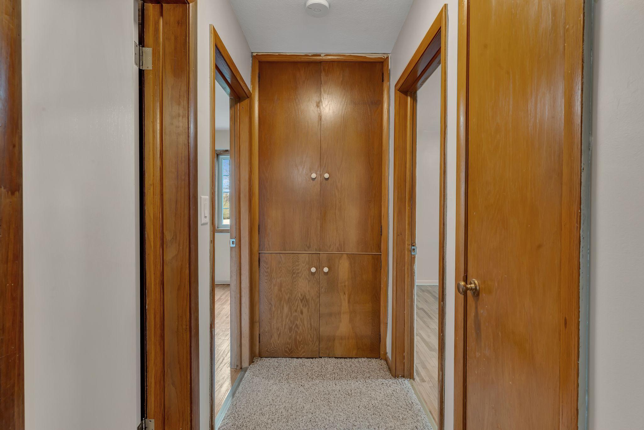 Built ins in the hallway serve as a linen closet