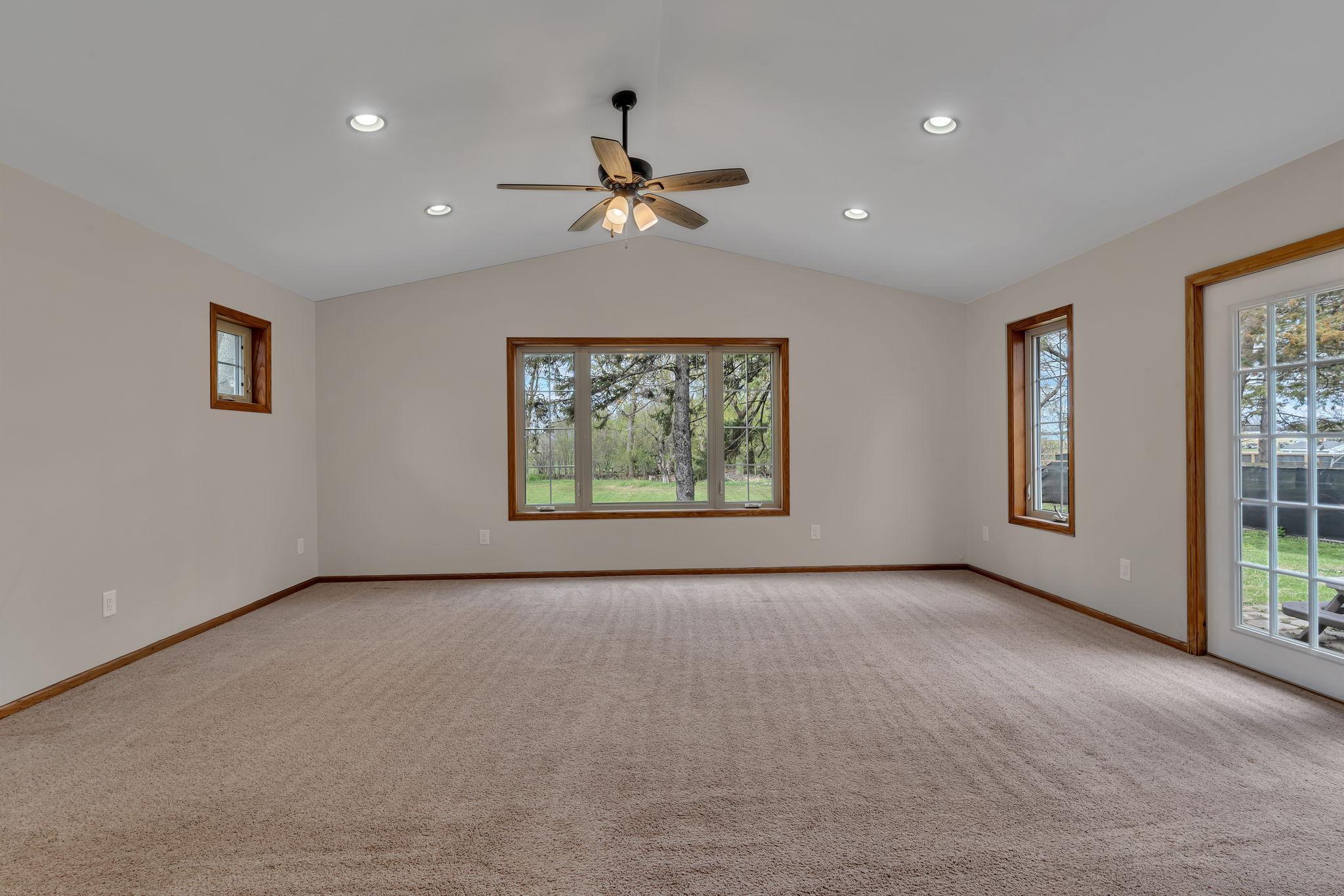 The living room addition is beautiful with backyard views and vaulted ceilings.
