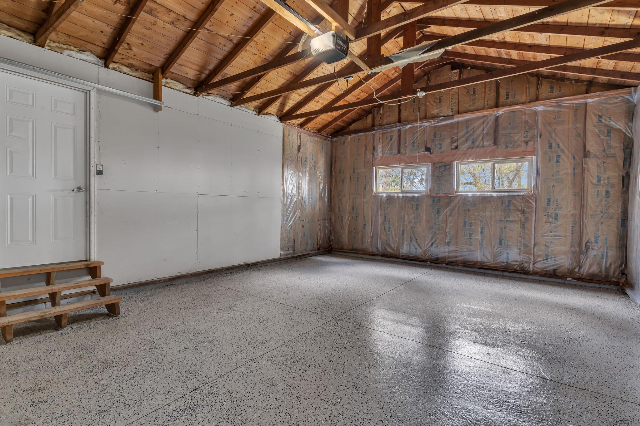 The attached garage is insulated and has a freshly painted epoxy floor.