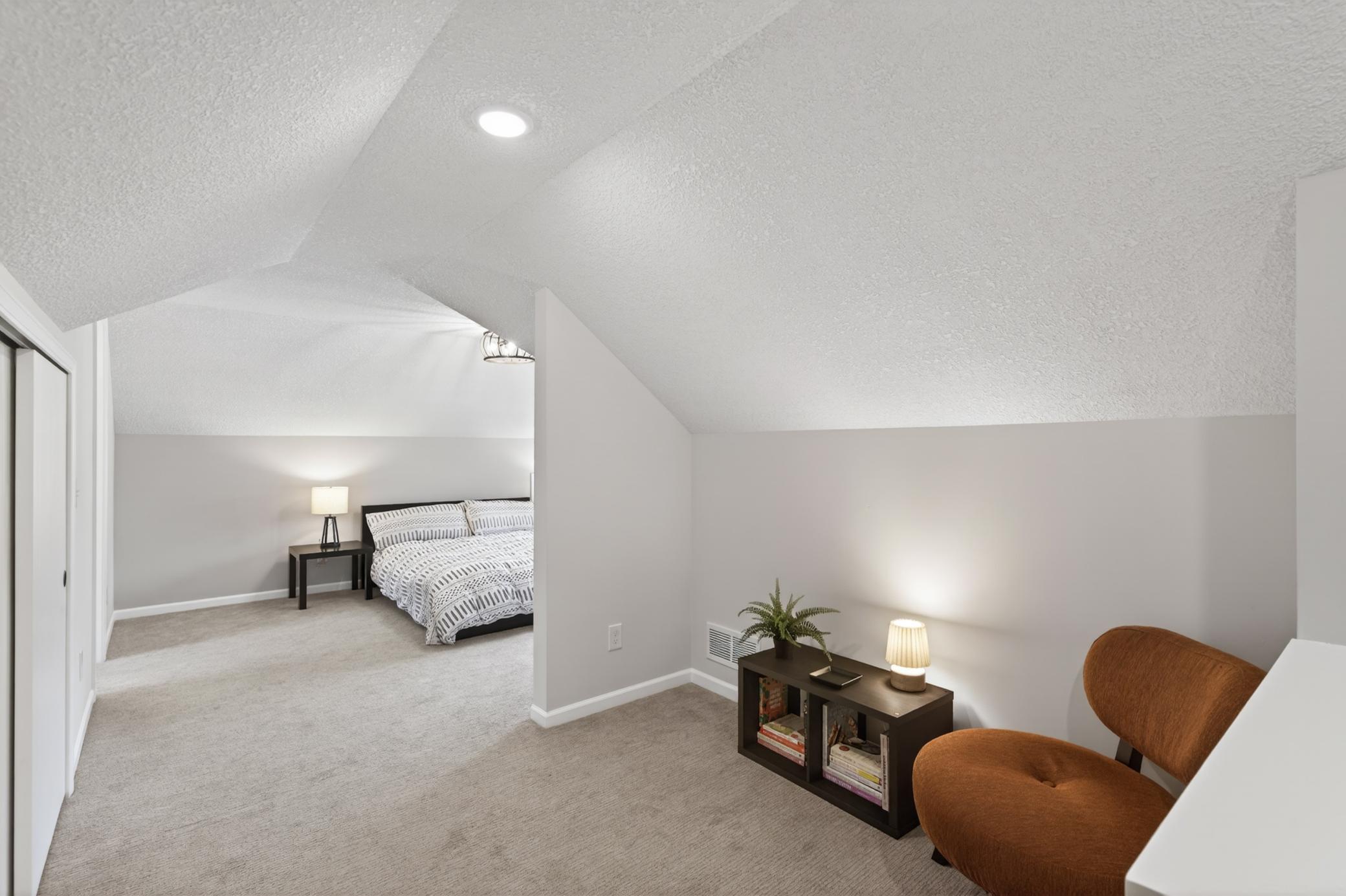 Upper level primary suite has a separate reading nook. Could also be used as office space.