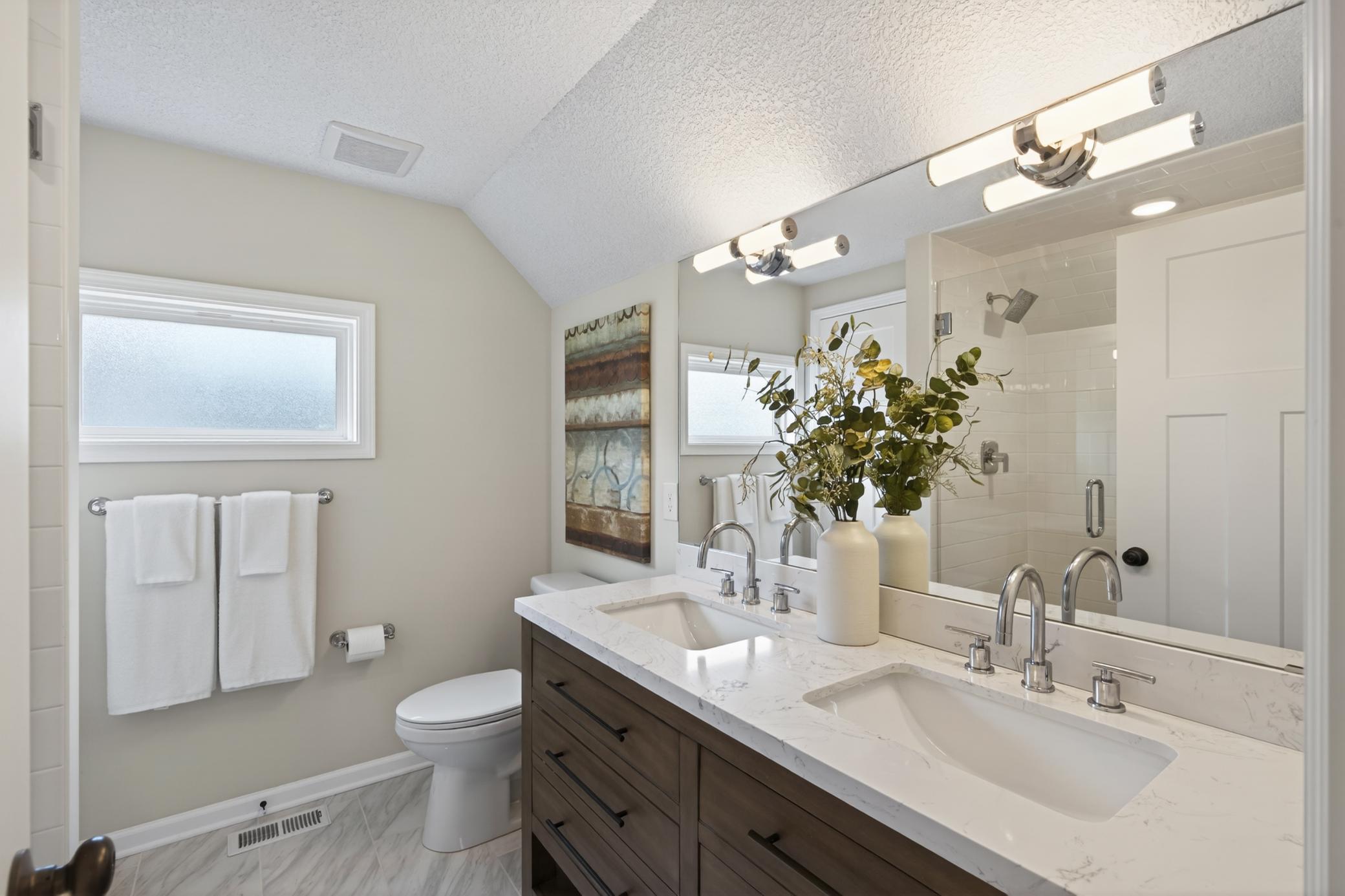 Primary suite bathroom has double sinks.