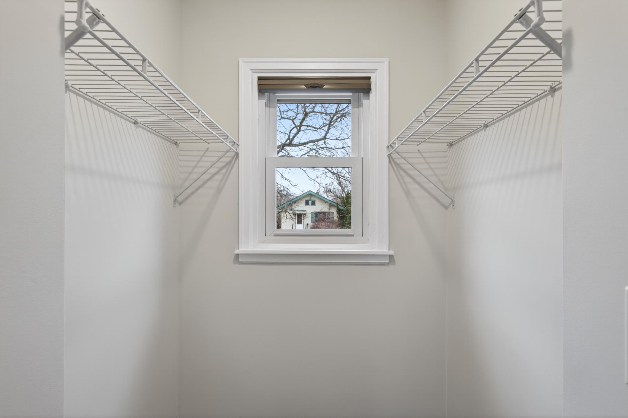 Walk-in closet in main floor bedroom