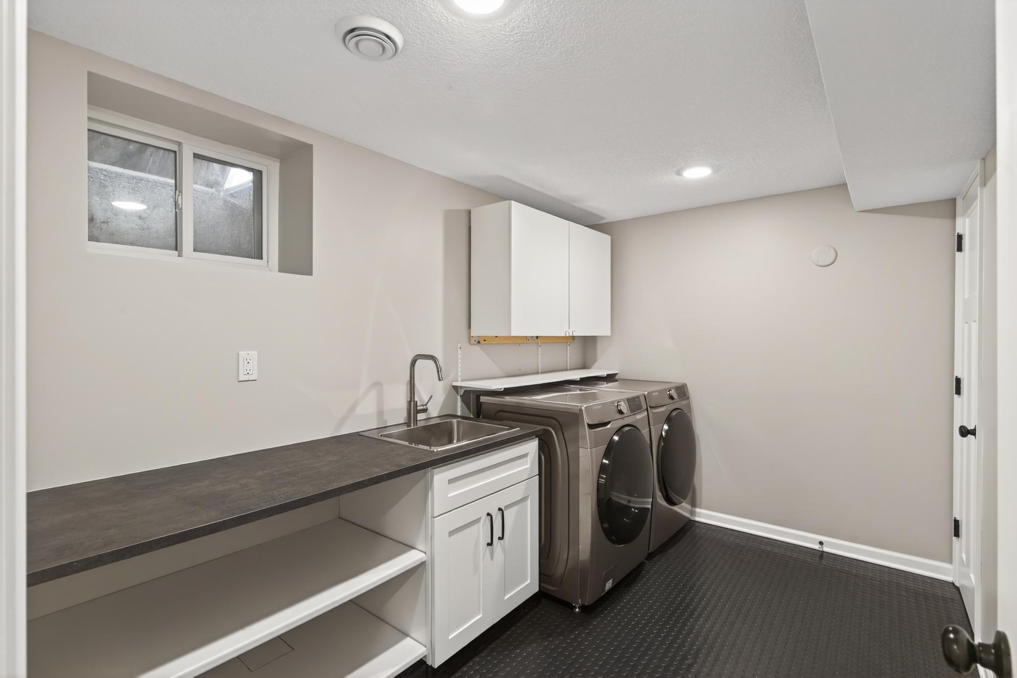 Laundry room was recently updated with new flooring and drain tile.