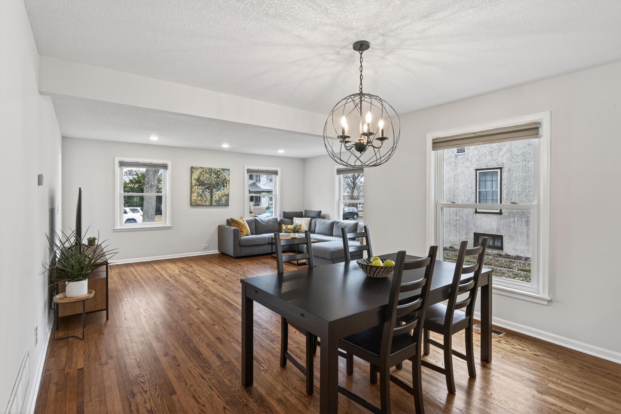 Recessed lighting and a custom chandelier brighten up the main floor living area.
