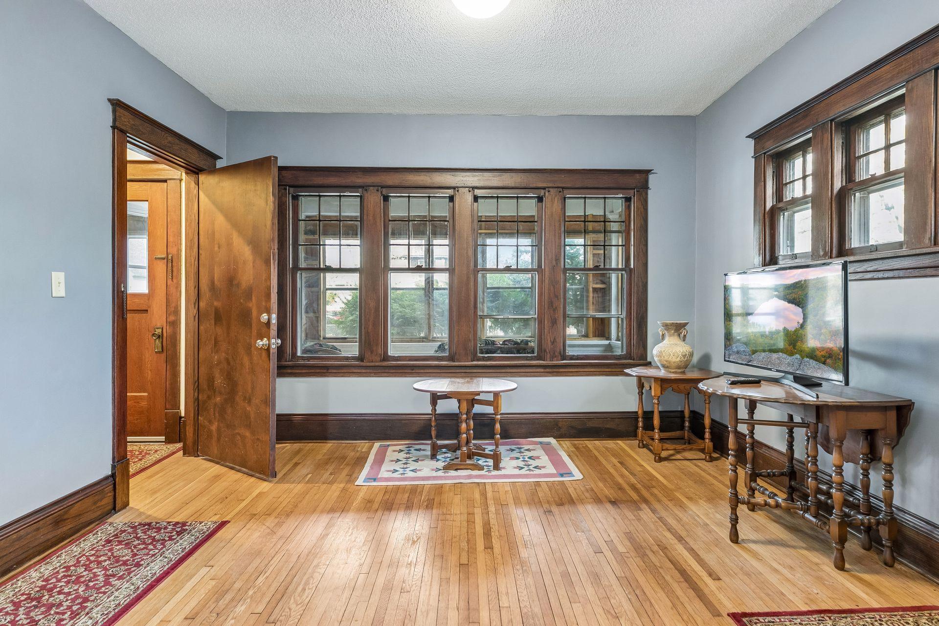 Charming woodwork details throughout the living room highlight the home’s preserved craftsmanship.