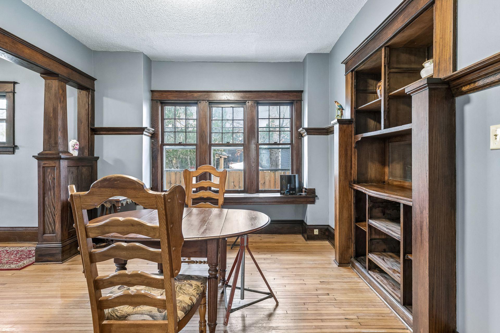 Large windows fill the space with natural light, enhancing the home’s warm and inviting feel.