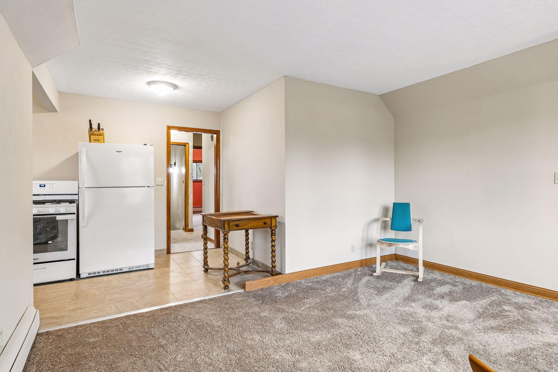 The upper-level living room flows seamlessly into the kitchen area.