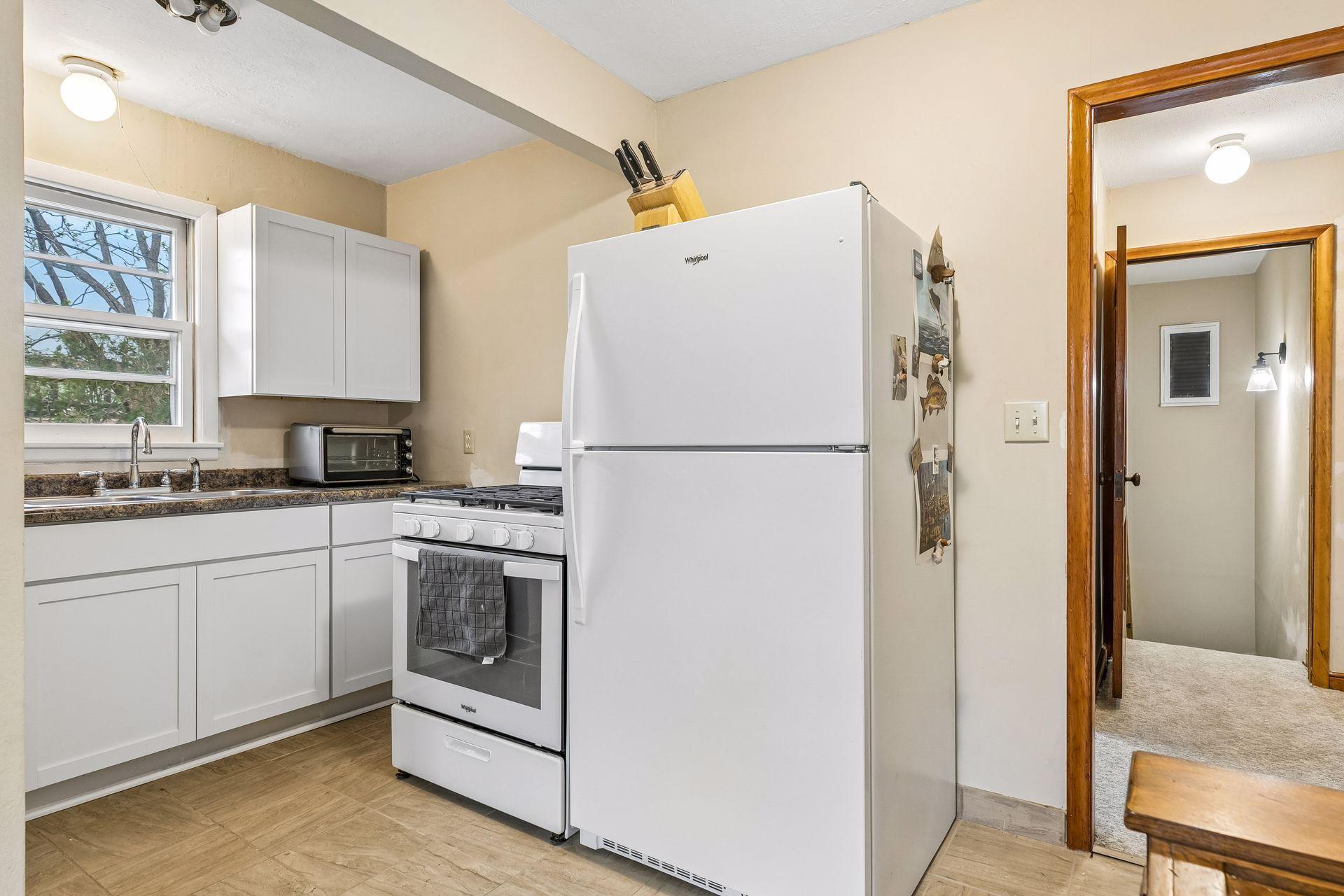 The upper-level kitchen has been updated to provide a functional and efficient space.