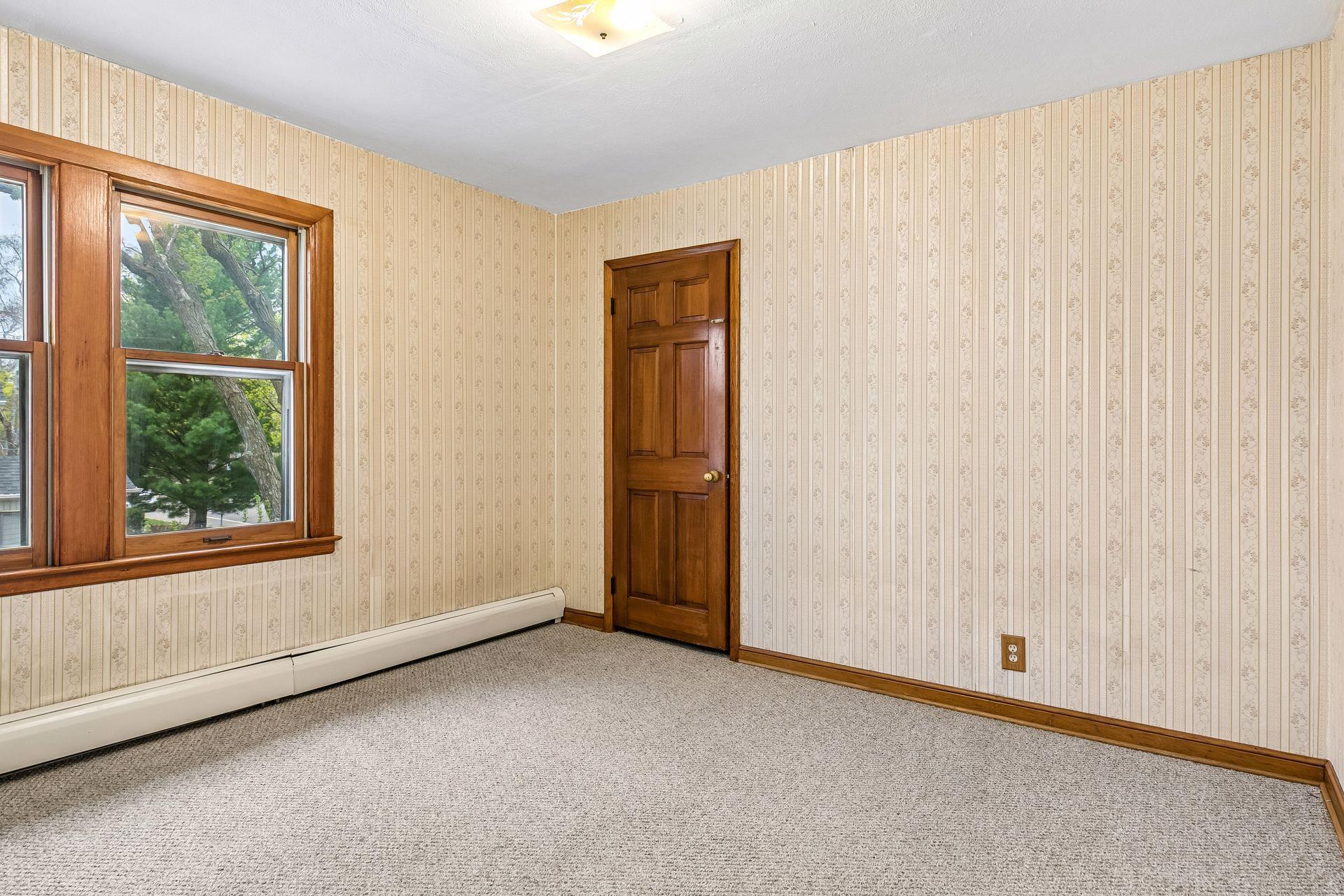 The first upper-level bedroom offers a comfortable and well-lit space.