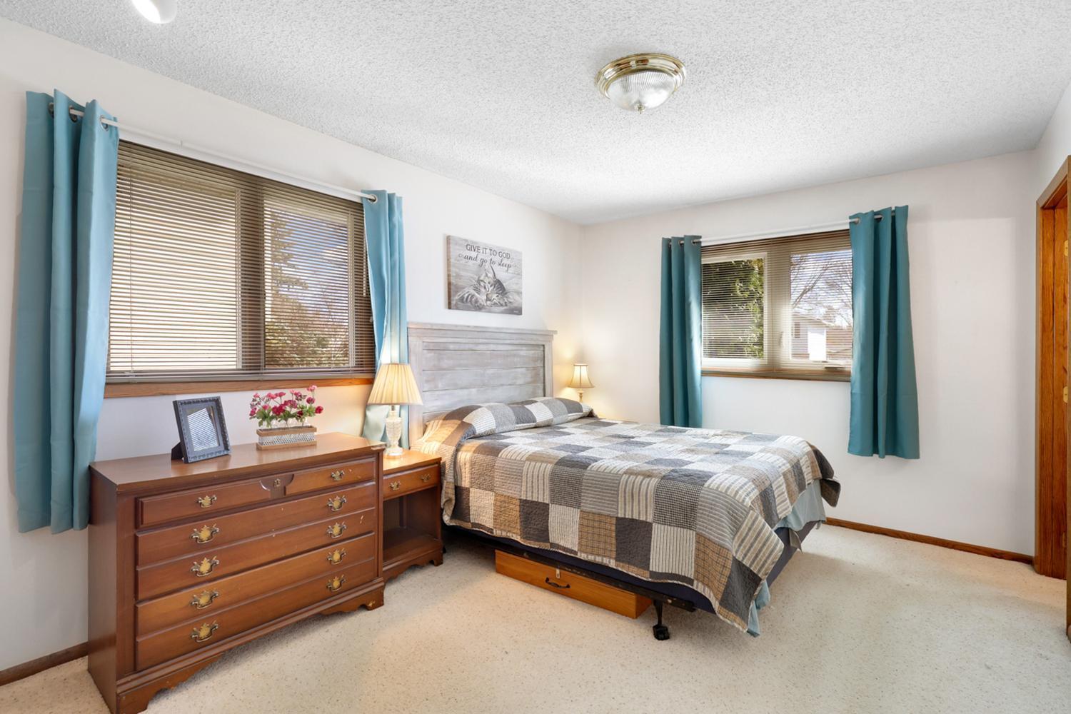 Relaxing owner’s bedroom with attached half bath perfect for added privacy and convenience.