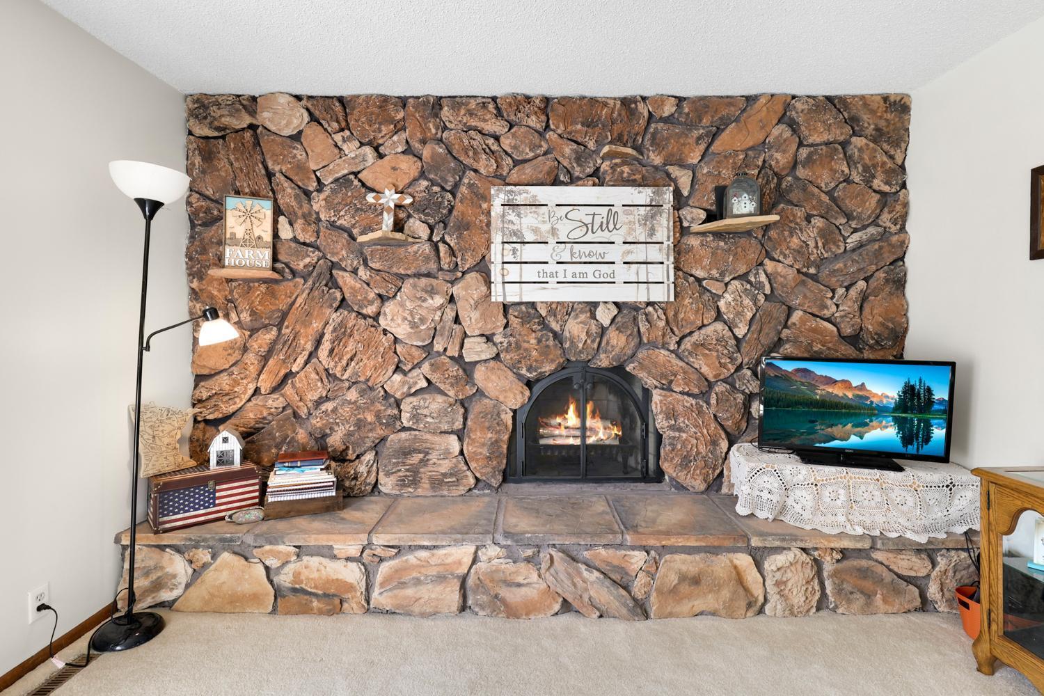 Striking natural stone fireplace adds character and charm, creating a cozy, lifestyle-driven space you’ll love year-round.