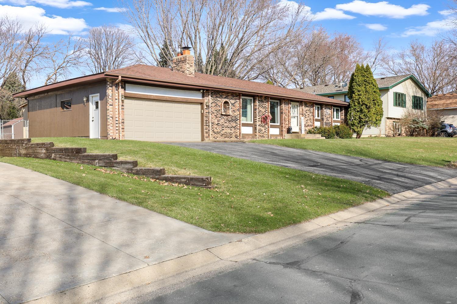 Beautifully maintained rambler nestled on a quiet Shakopee street with incredible curb appeal. The spacious lot offers a flat yard, mature trees, and a welcoming approach with an extended driveway and attached garage.