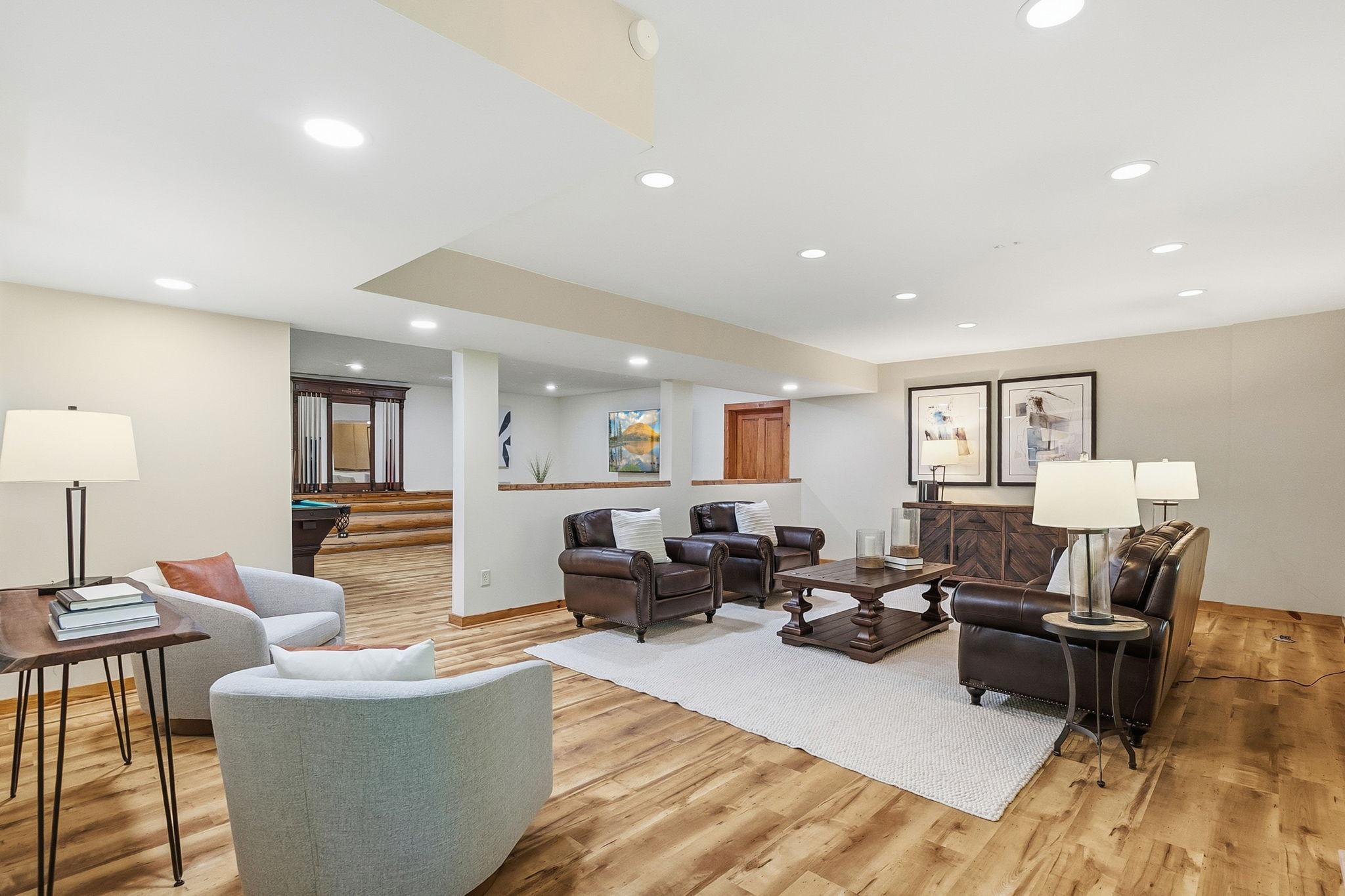 A spacious lower-level living area with an open layout and abundant potential; perfect for creating a comfortable family room, media space, or everyday gathering hub.