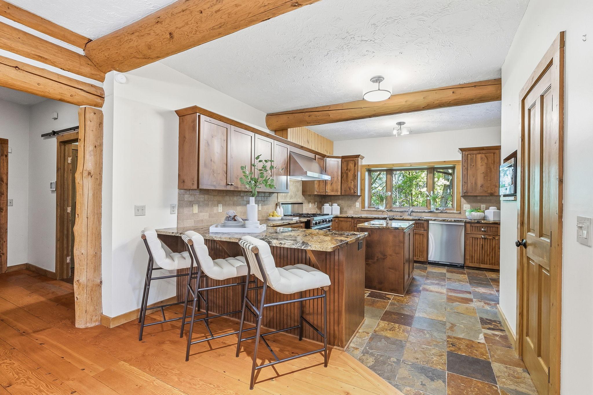 The kitchen offers a warm, inviting nook with rich wood tones and a cozy, tucked-in feel; perfect for casual dining, morning coffee, or gathering conversations.