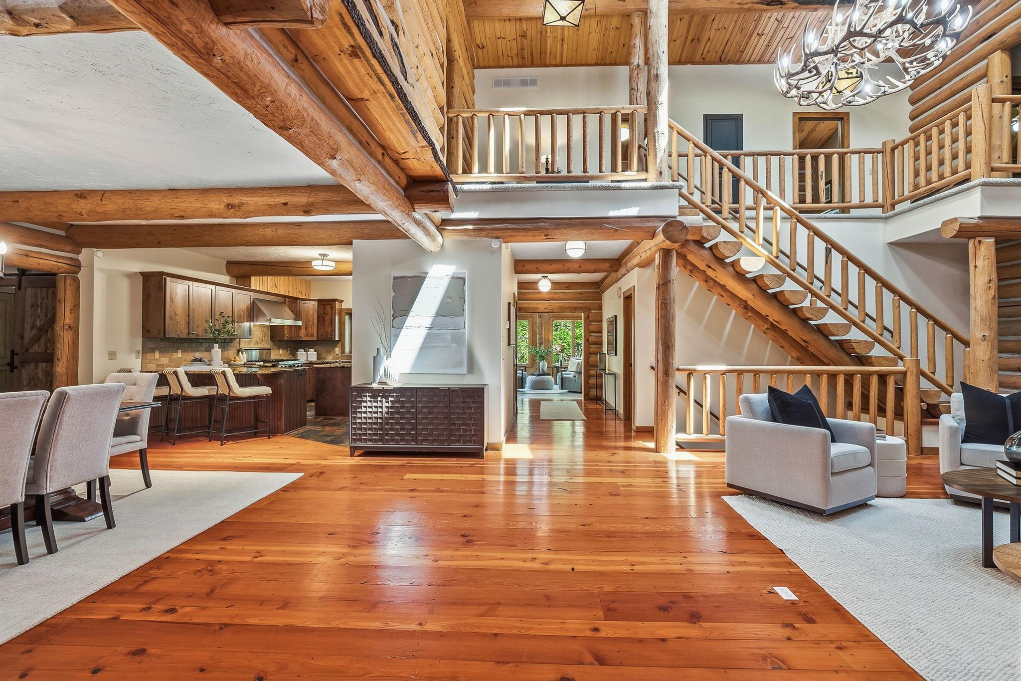 A striking handcrafted log staircase that serves as a true architectural focal point, seamlessly connecting levels while showcasing the home’s authentic rustic craftsmanship.