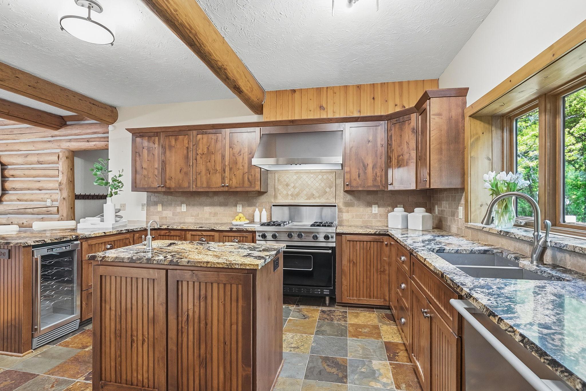 The kitchen offers a warm, inviting nook with rich wood tones and a cozy, tucked-in feel; perfect for casual dining, morning coffee, or gathering conversations.