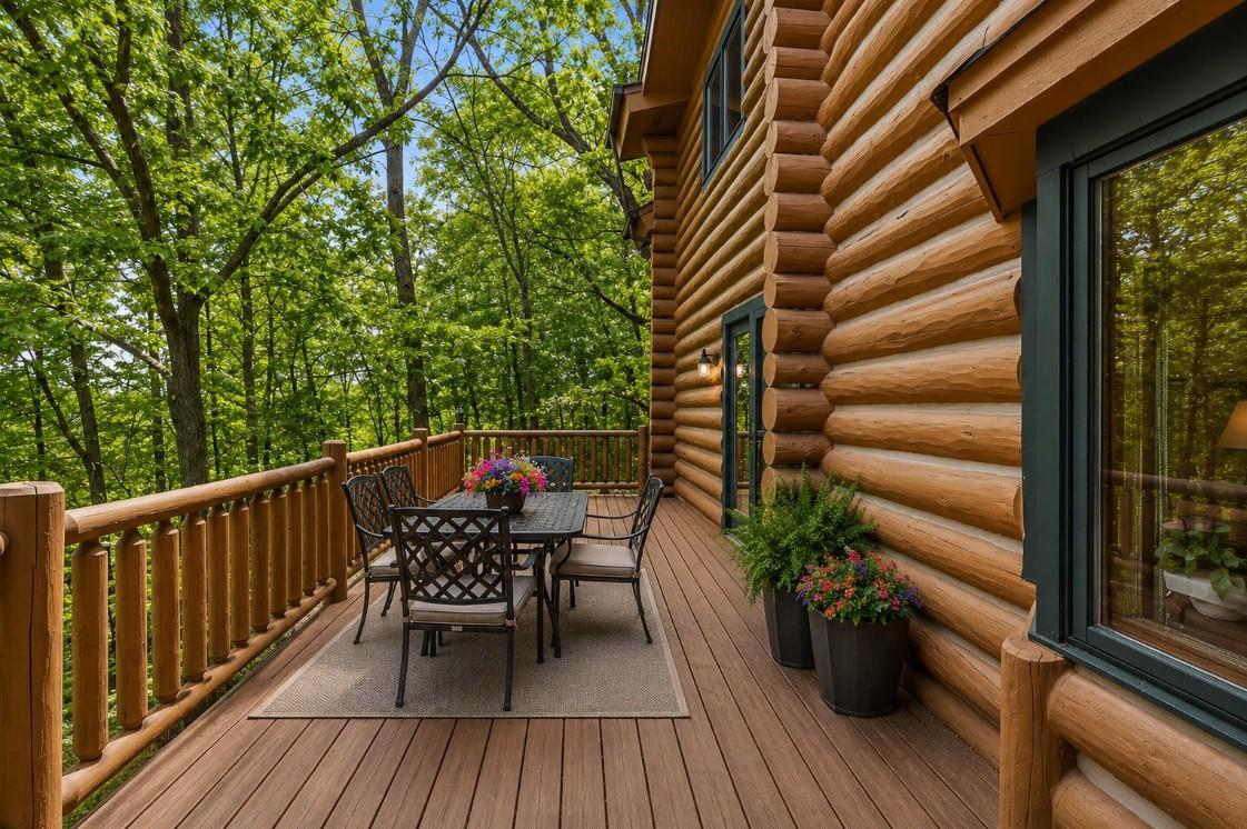 An expansive deck overlooking a serene, tree-lined backyard; offering the perfect setting for outdoor dining, relaxation, and enjoying peaceful, nature-filled views (virtually staged)