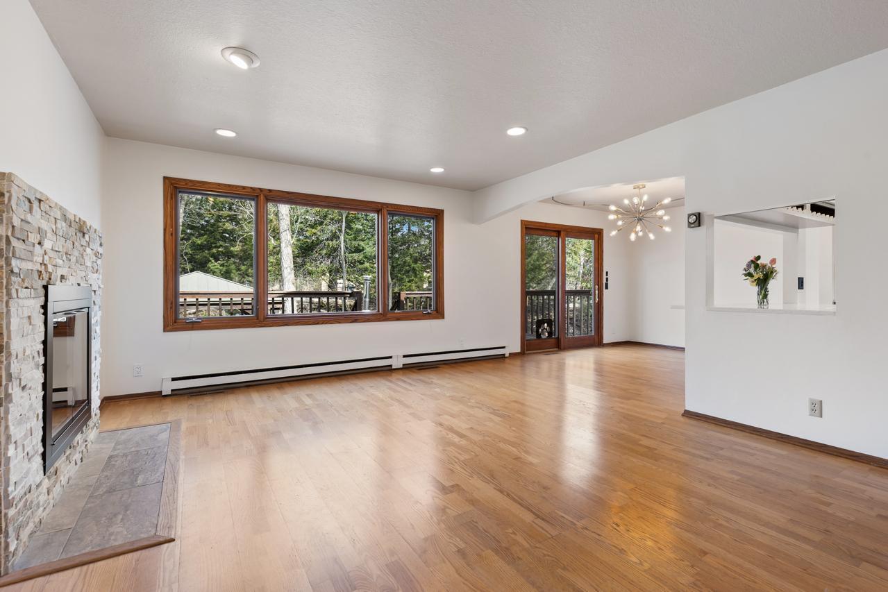 Light and Bright living room leads into dining area with access out to the deck.