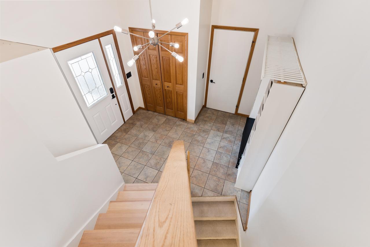 Foyer leads up to main level and down to finished lower level. Door to garage.