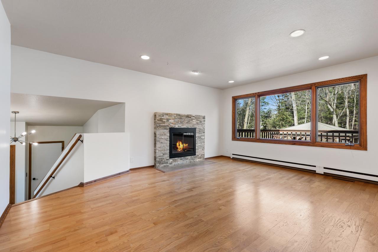 Large living room with wood burning fireplace.
