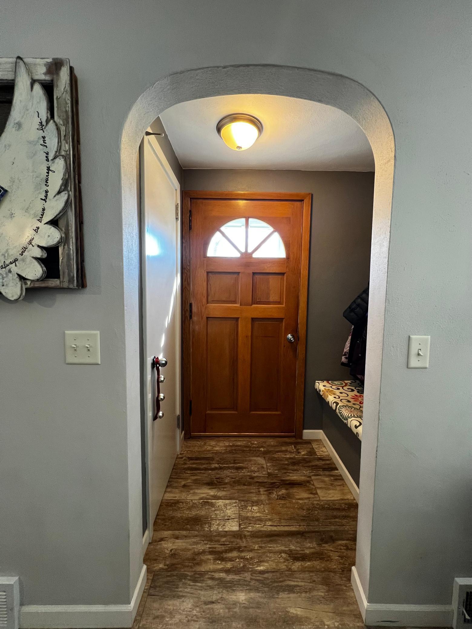 Front Door & Foyer with Closet, Bench and coat hooks.