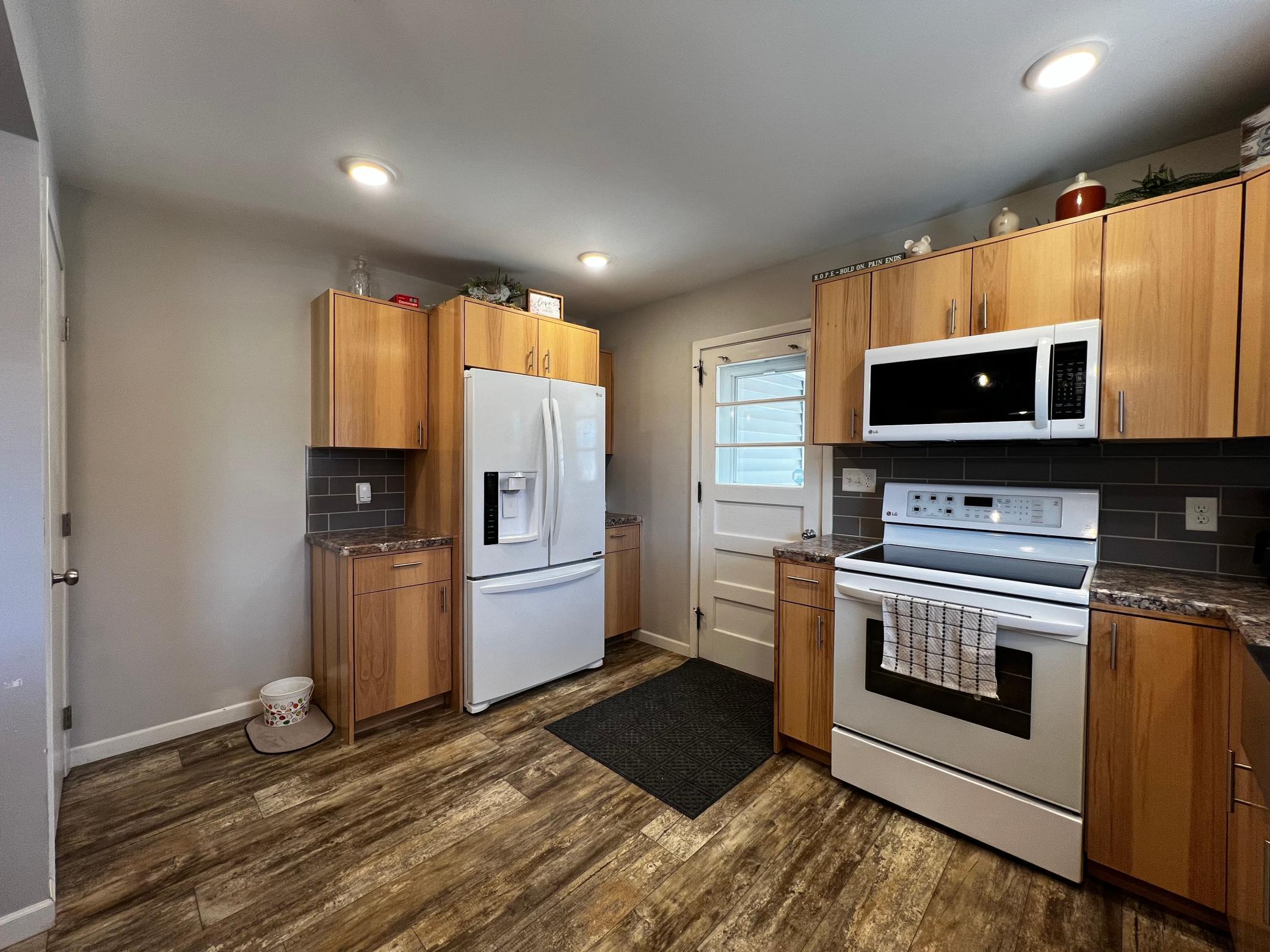 Kitchen view including door to the basement and door to the carport.