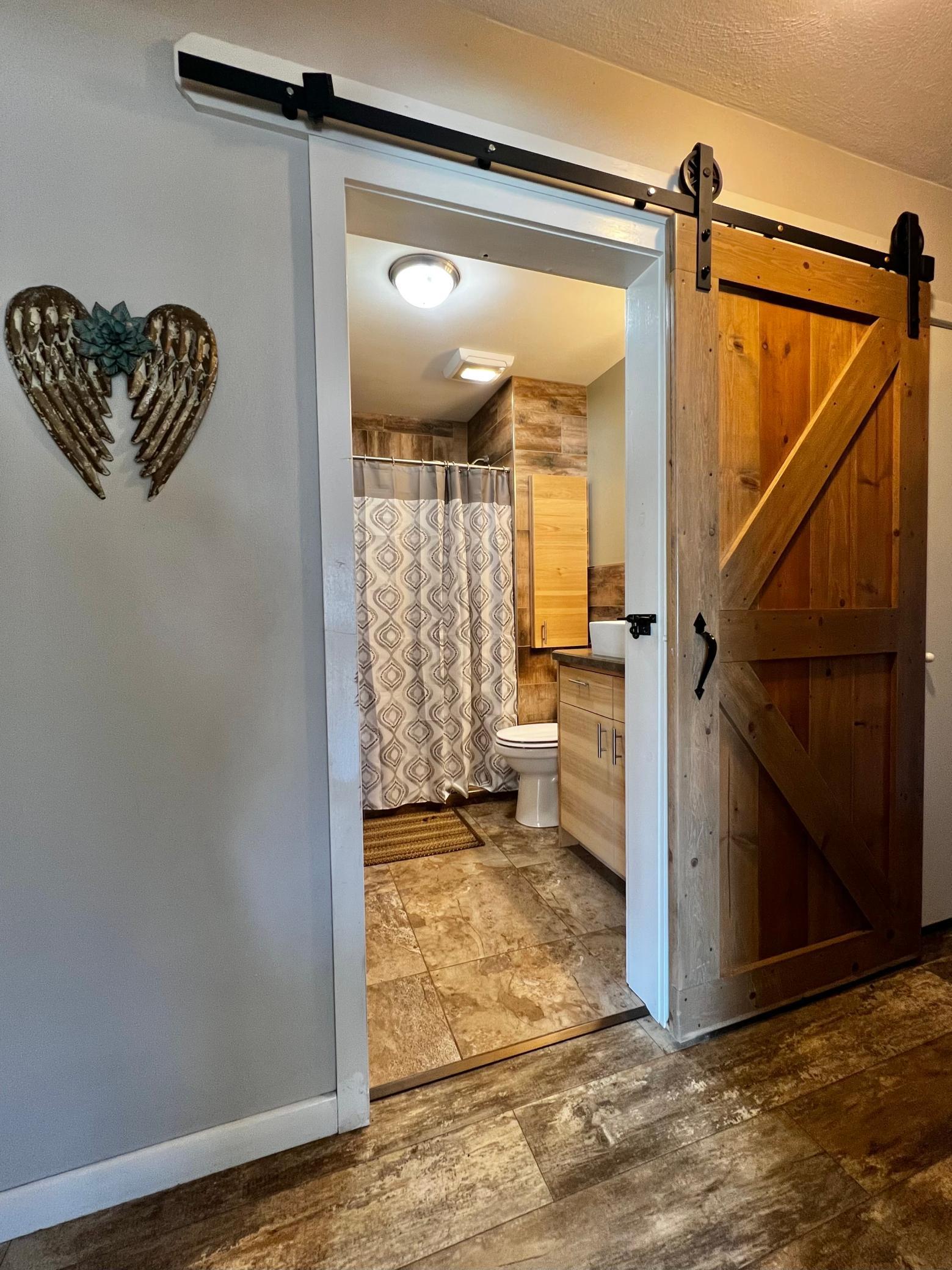 Main floor 3/4 Bathroom, Beautiful Tiled 3/4 Bathroom with Barn Door